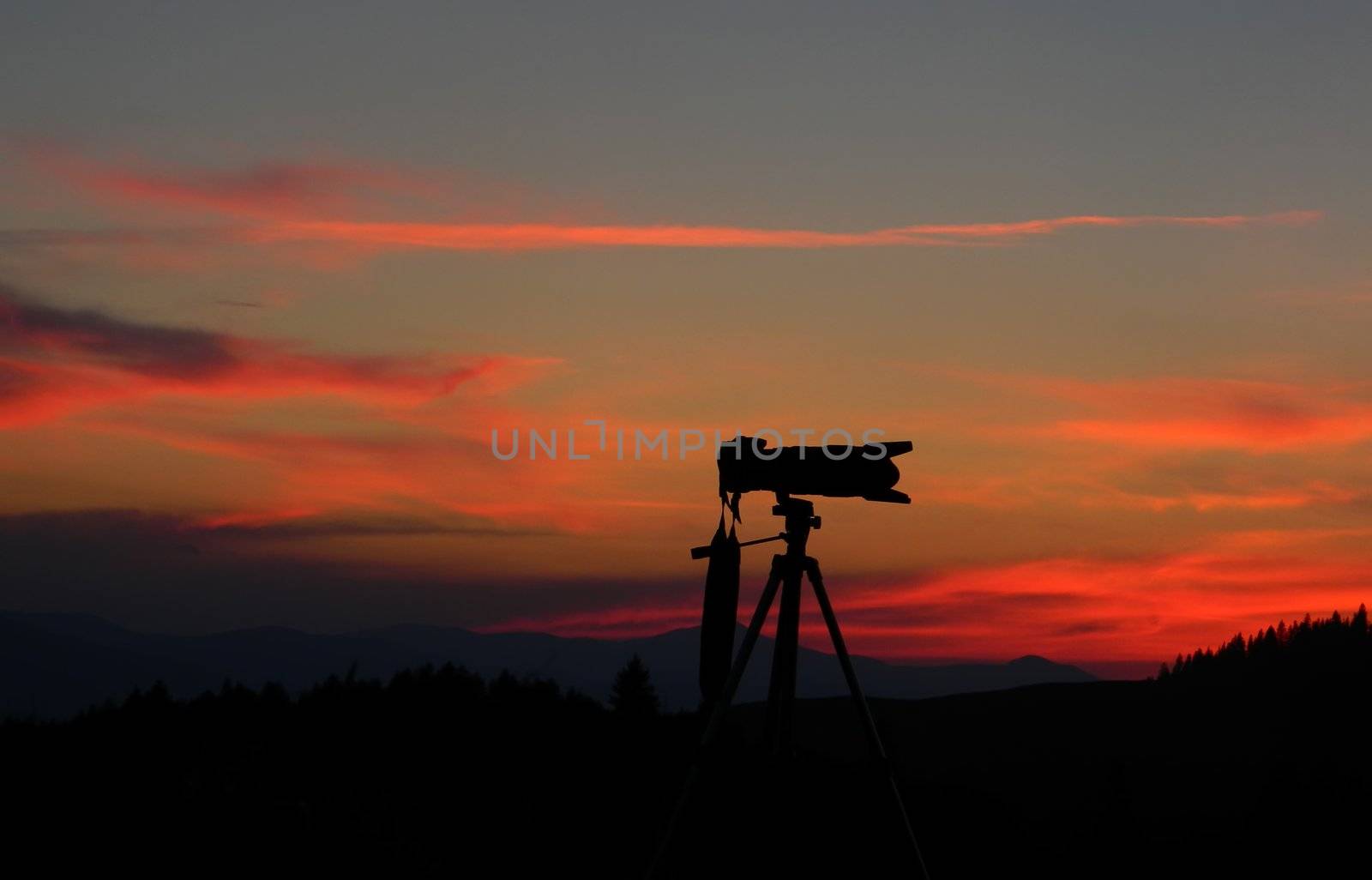 silhouette of a digital photo camera at sunset