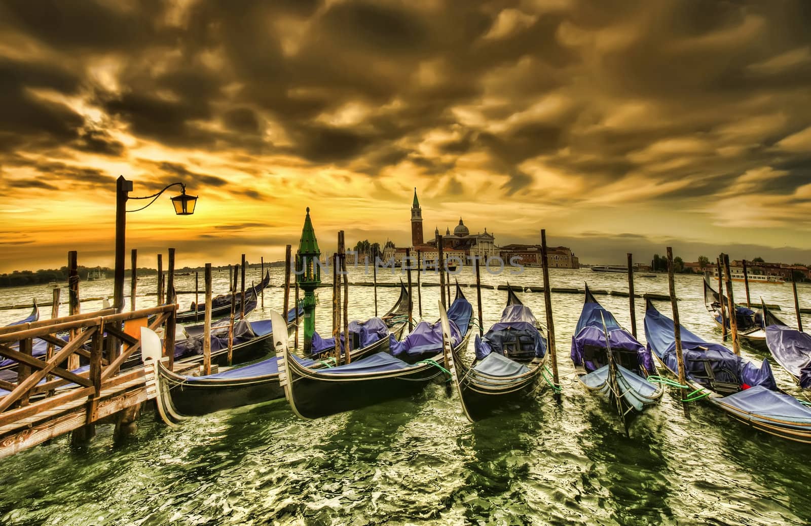 Venice dramatic scene with gondolas at sunset, Italy