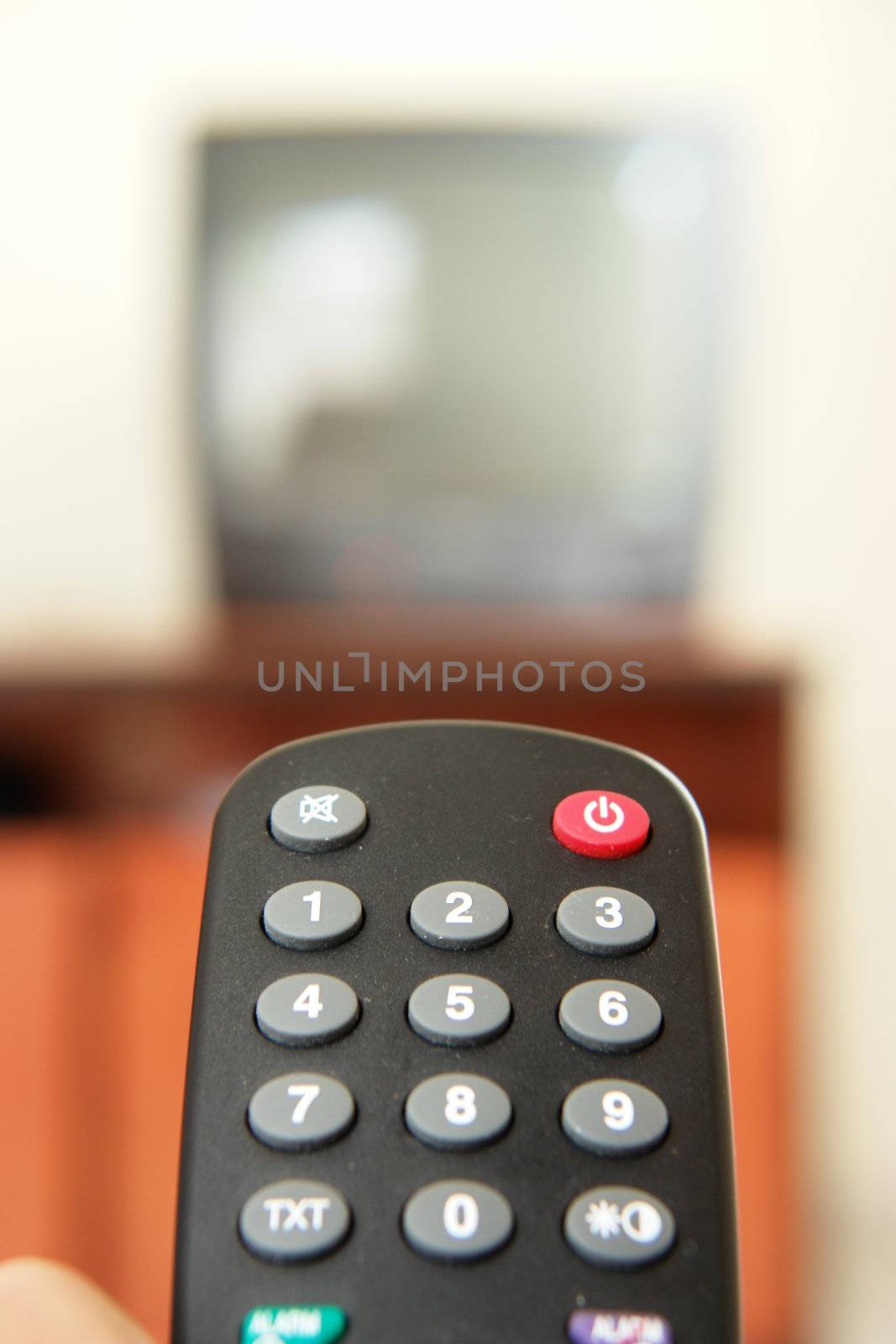 Television screen with tv remote control  in foreground