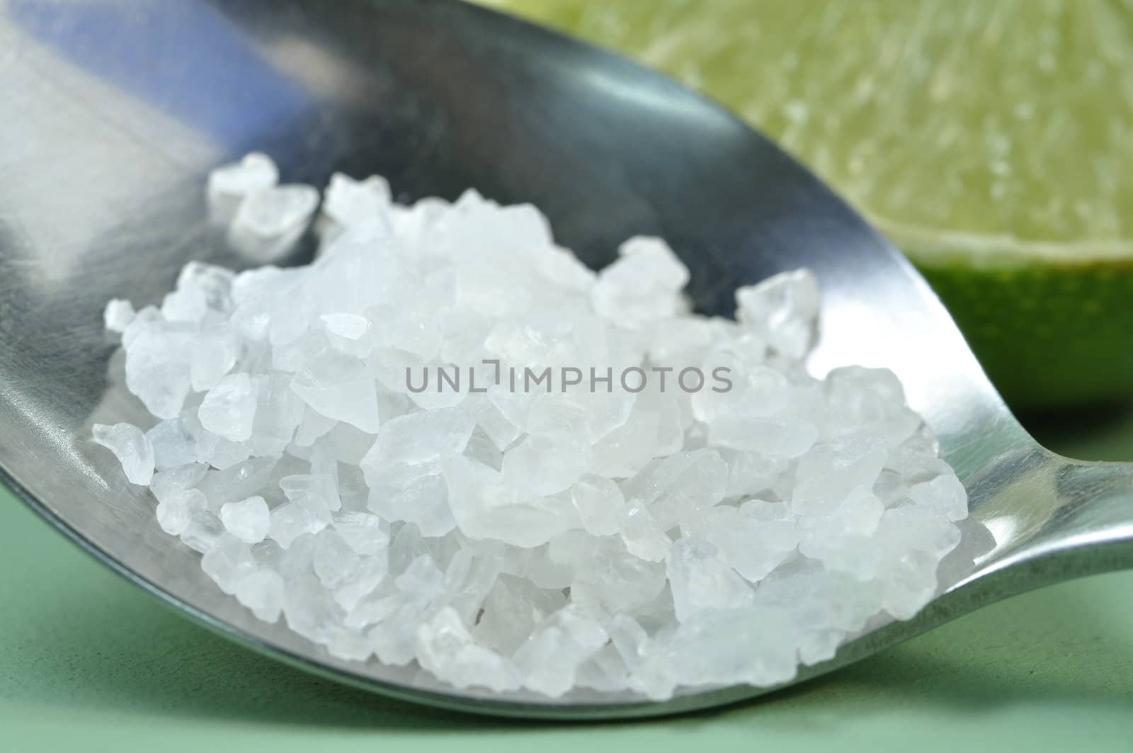 Macro closeup of a spoonful of sea salt granules