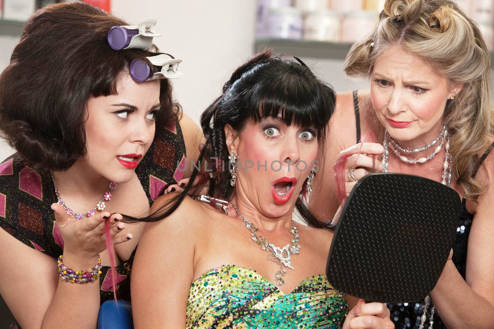 Shocked mature woman with sympathetic friends in hair salon