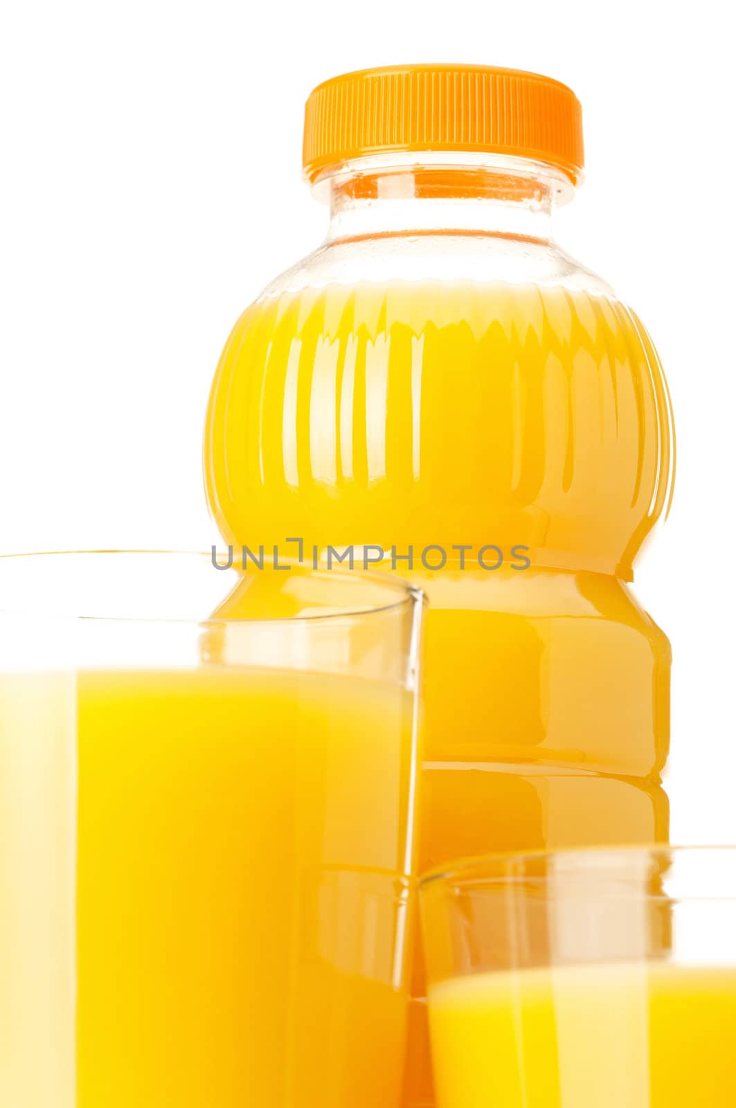 Orange juice in plastic bottle and glass on white background