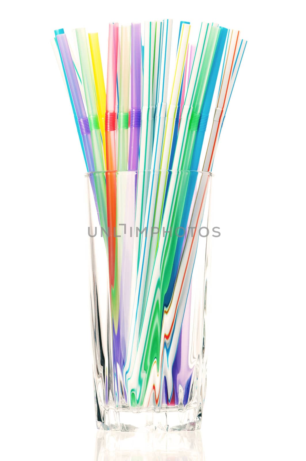 Colorful cocktail straws in glass on a white background