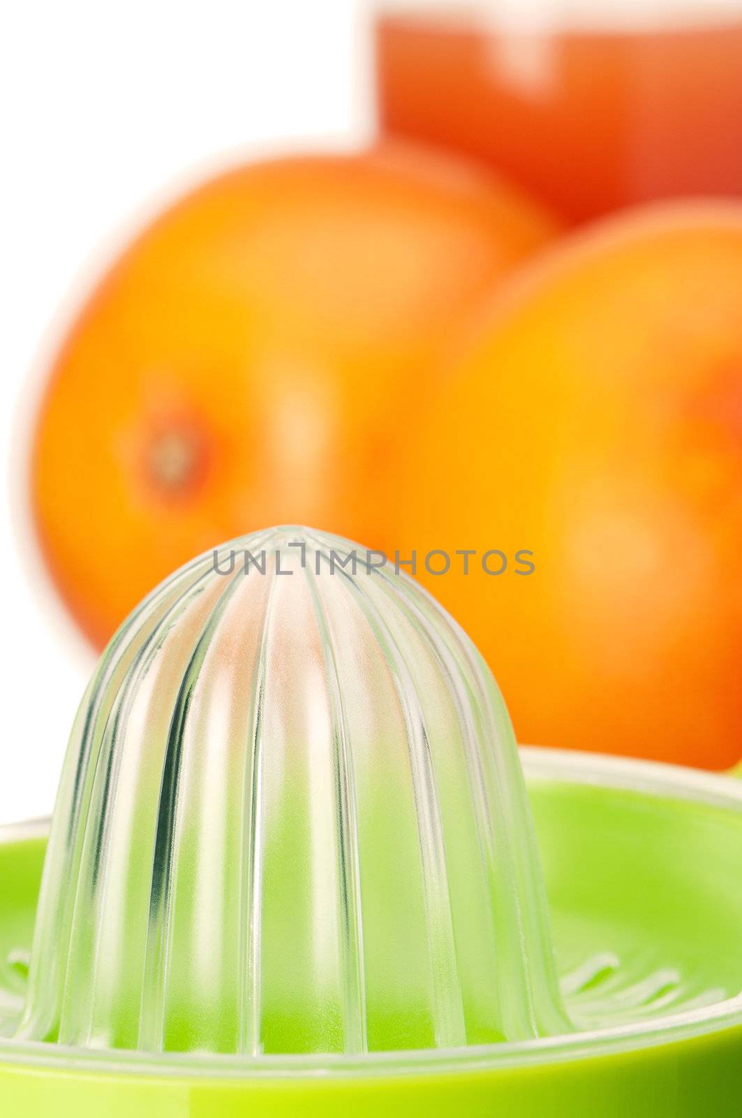 Glass of fresh grapefruit juice, juicer and grapefruit fruits on white background