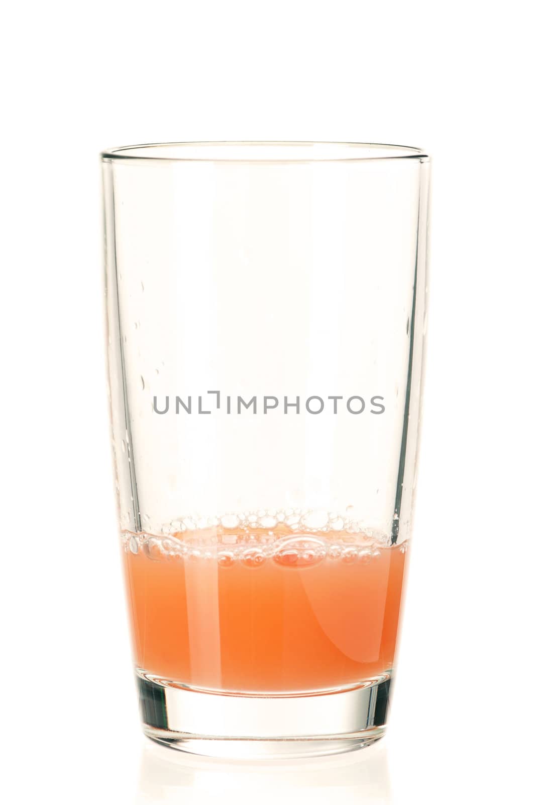 Glass of fresh grapefruit juice on white background