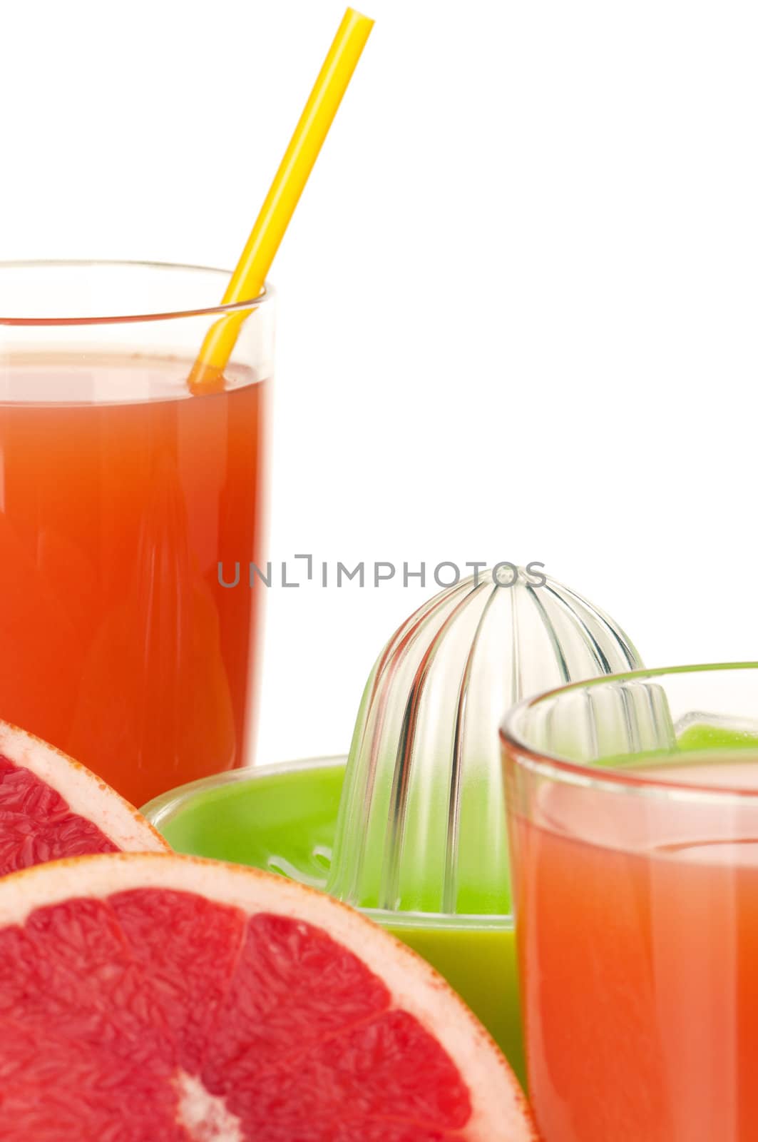 Glass of fresh grapefruit juice, juicer and grapefruit fruits on white background