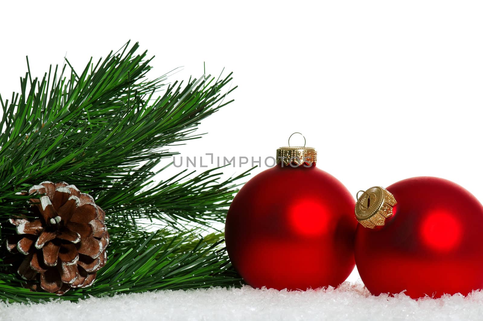 Red christmas baubles with snow on white background