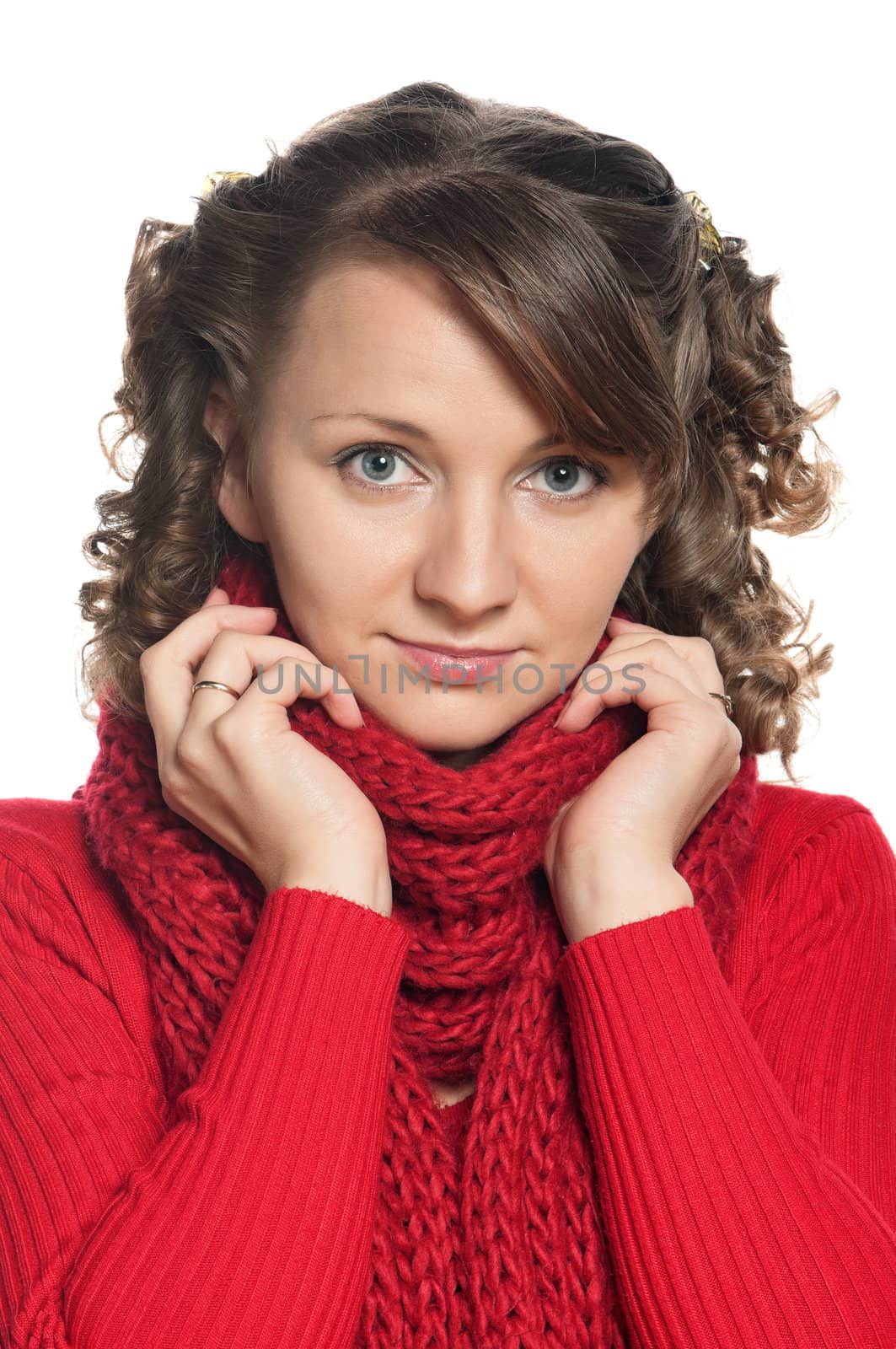 Portrait of a young woman in warm sweater and scarf with happy smile posing on white