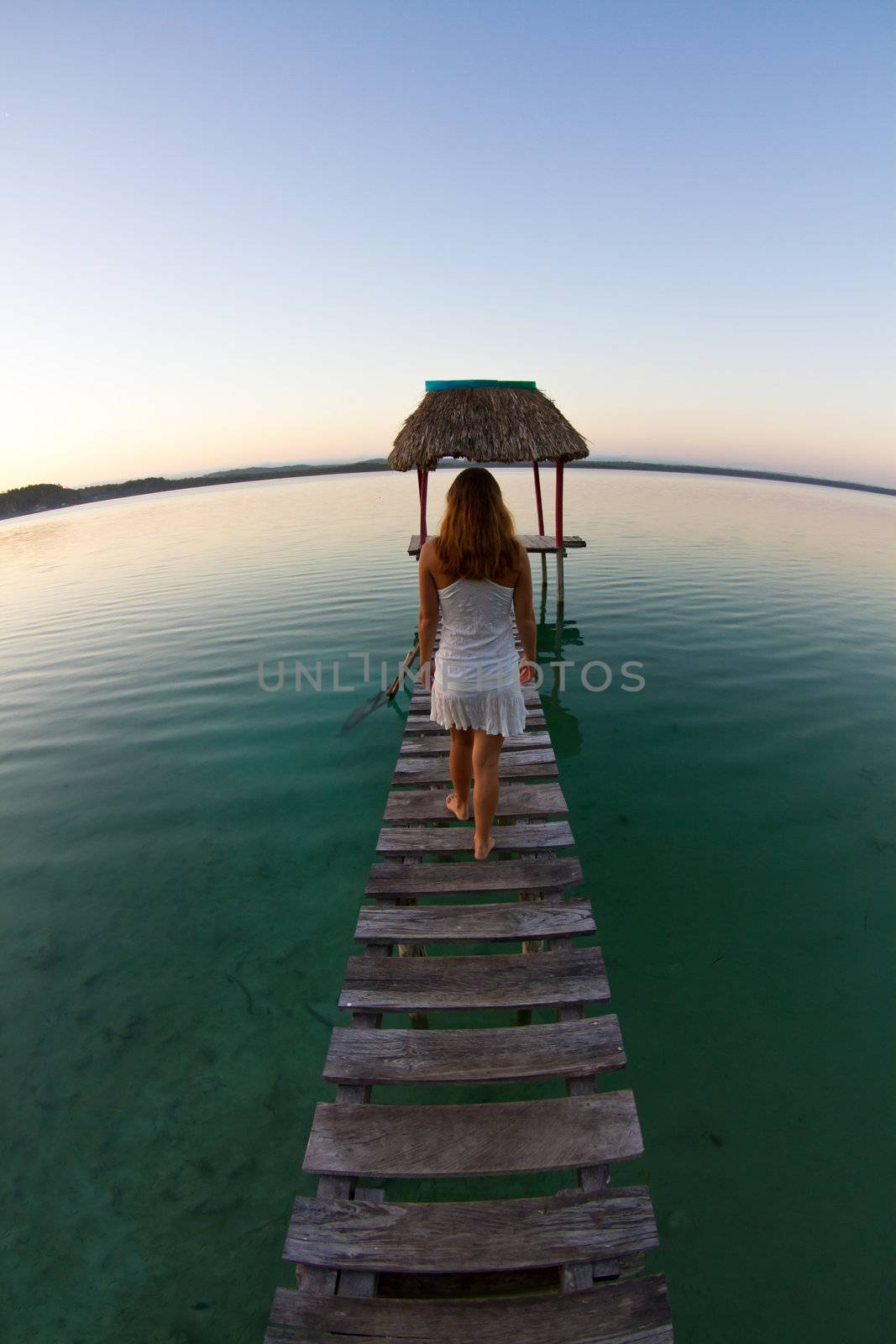 A young woman enjoys the early morning on the lake