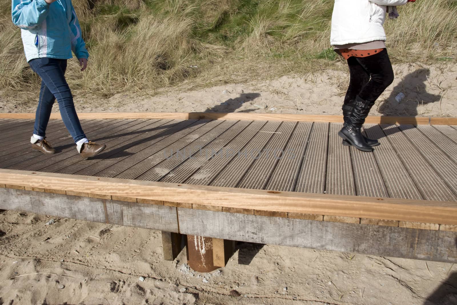 mother and daughter on Youghal beach boardwalk by morrbyte