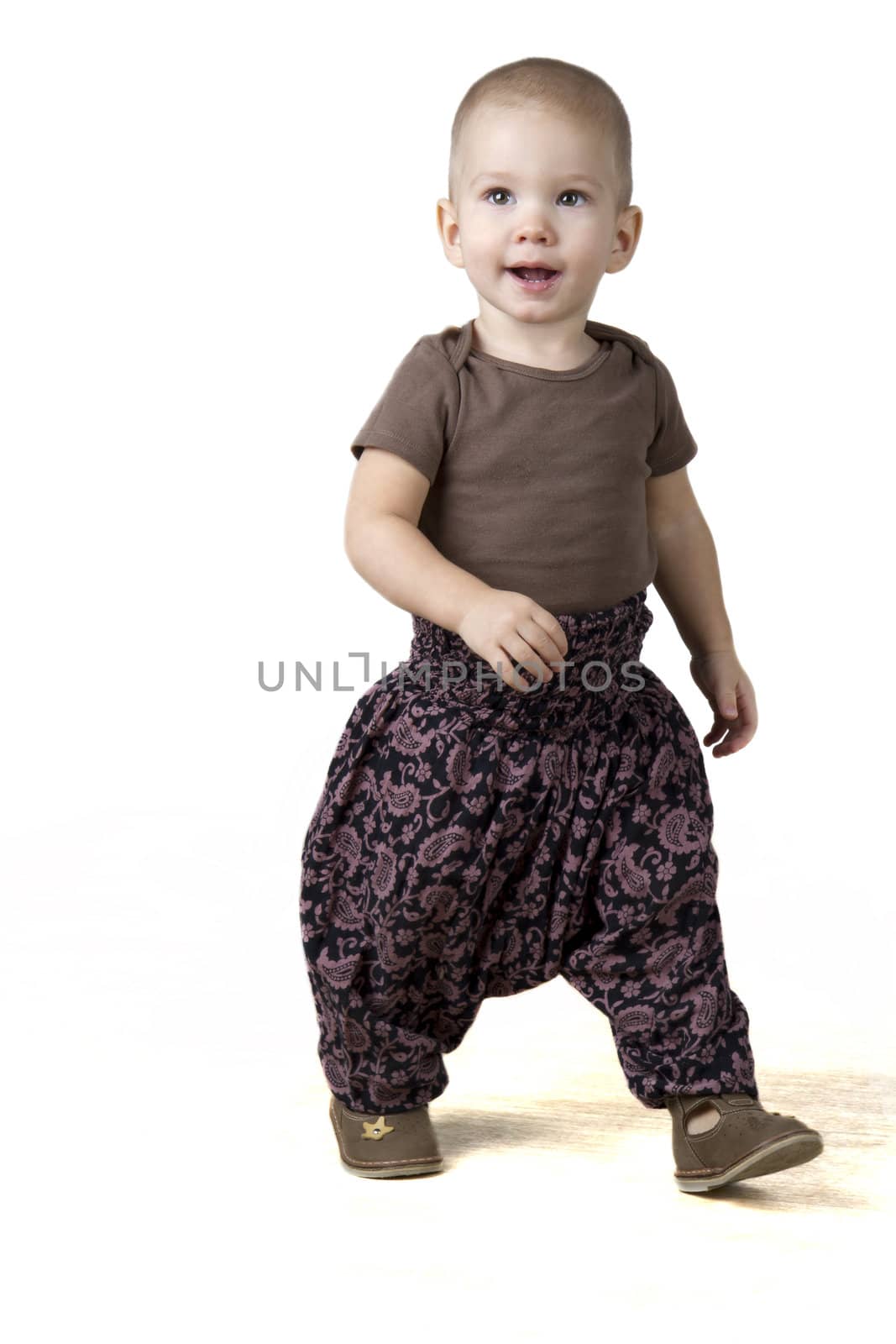 happy child walking in the ethnic pants