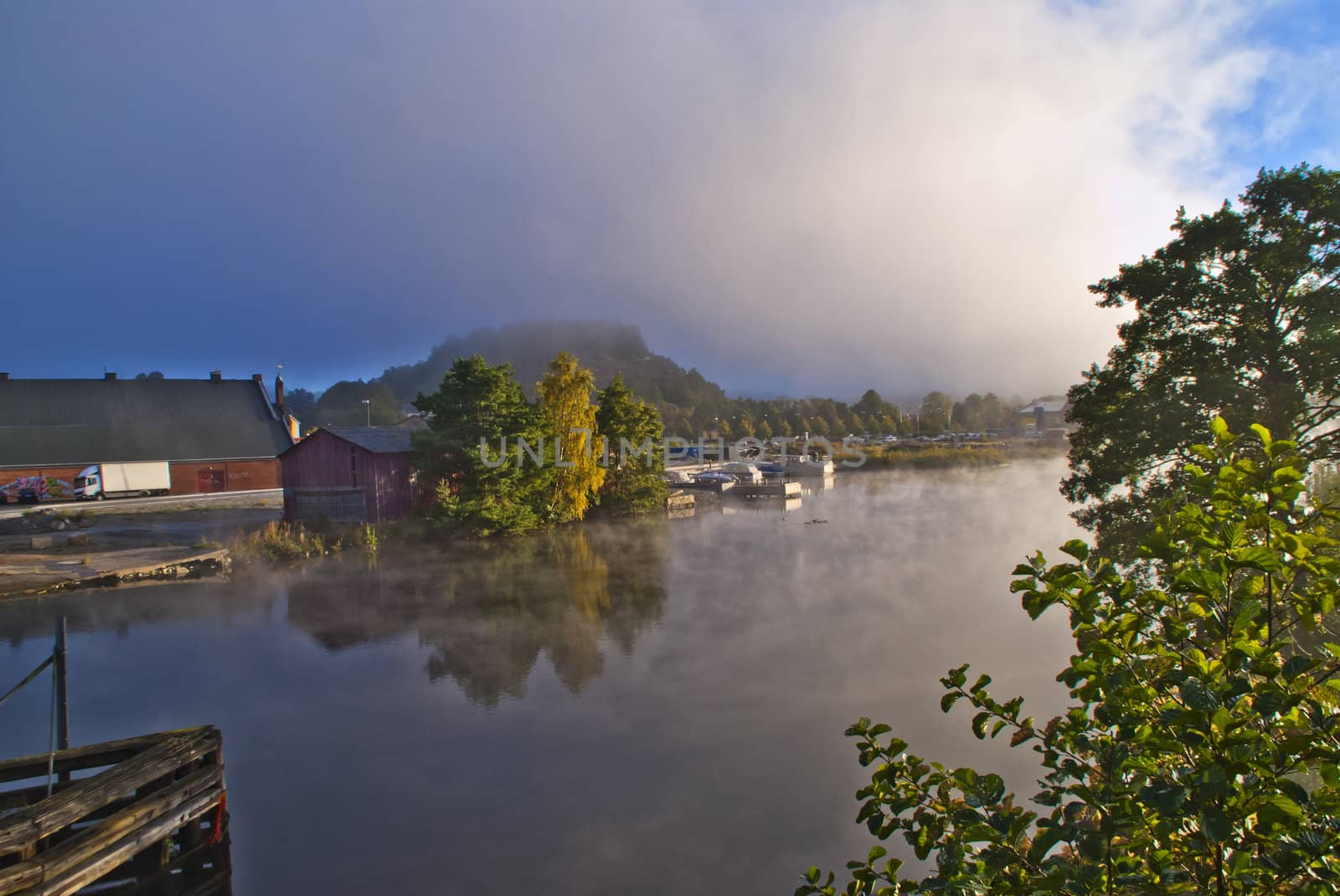 fog and smoke in the tista river in halden, image is shot on a cold autumn morning.