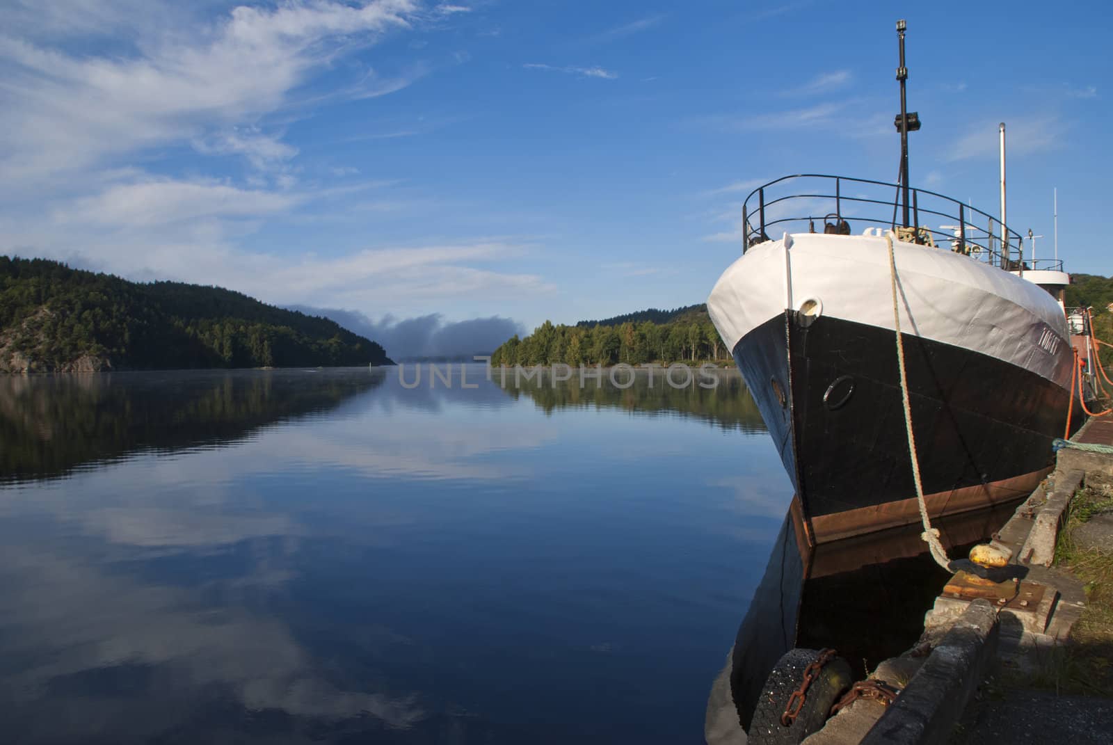 the boat is moored to the dock at the port of halden