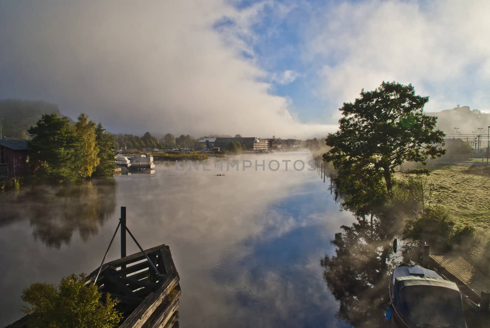 fog and smoke in the tista river in halden, image is shot on a cold autumn morning.