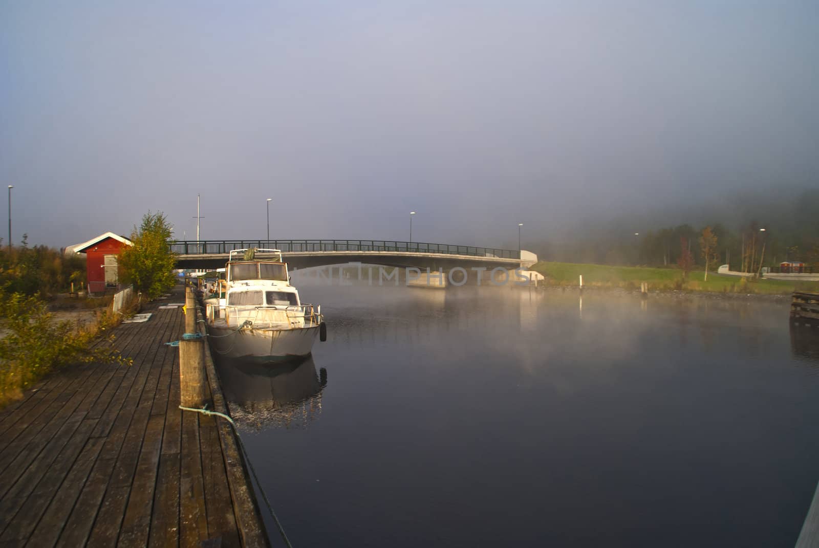 fog and smoke in the tista river in halden, image is shot on a cold autumn morning.