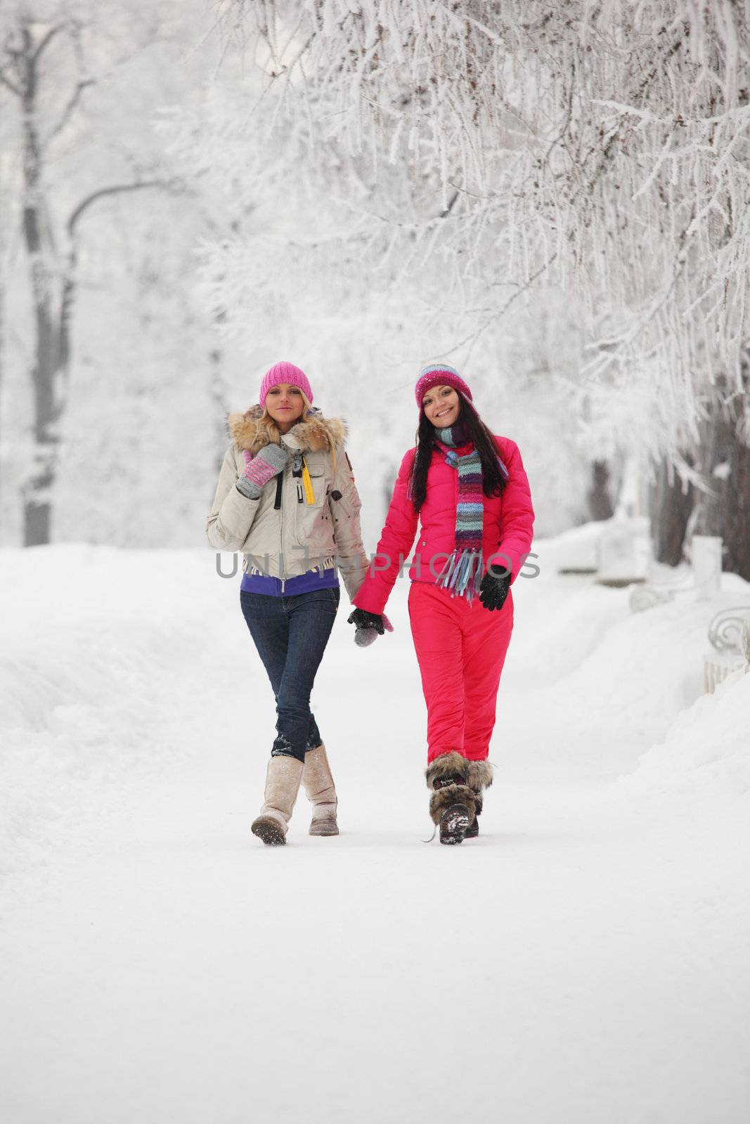 two winter women run by snow frosted alley