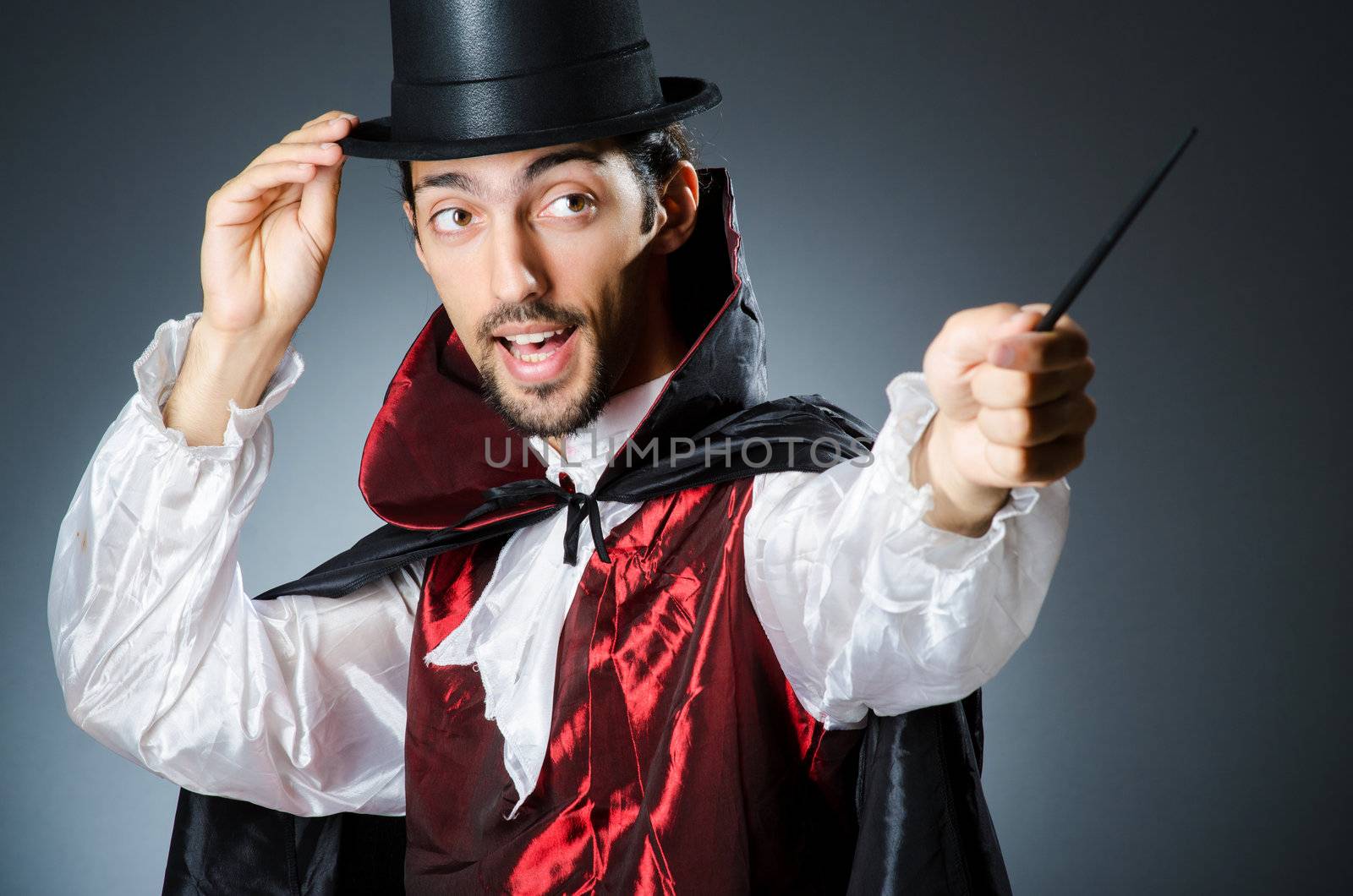 Magician doing tricks in dark room