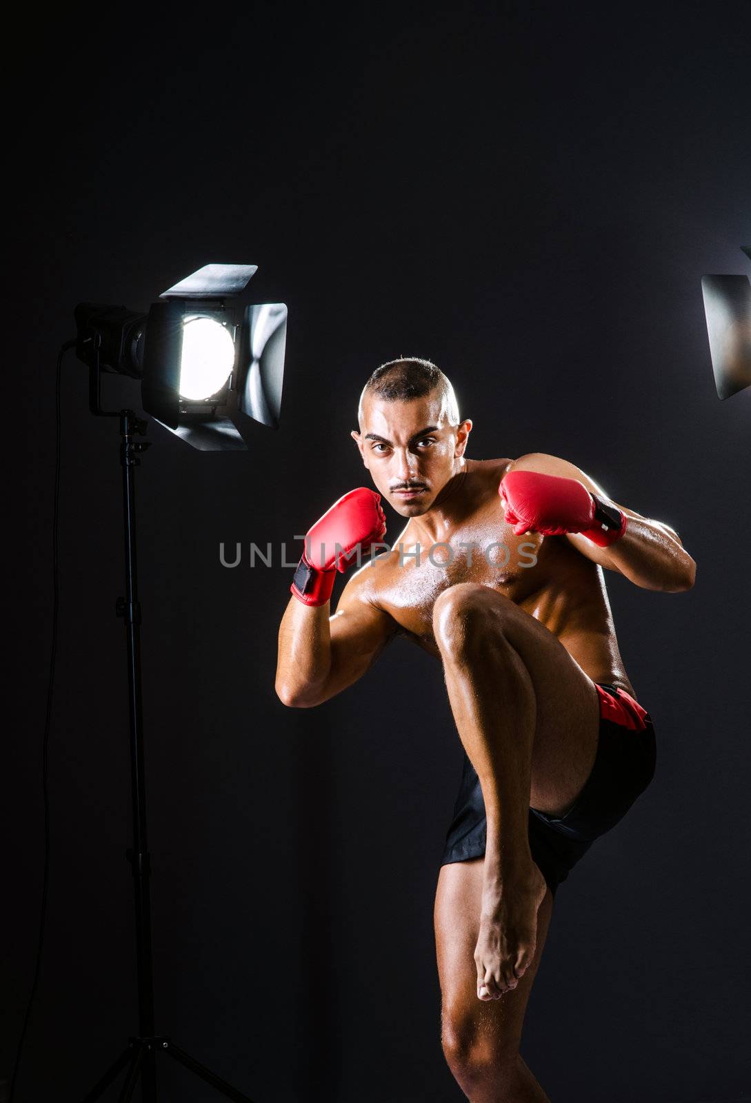 Boxer with studio lights in sports concept