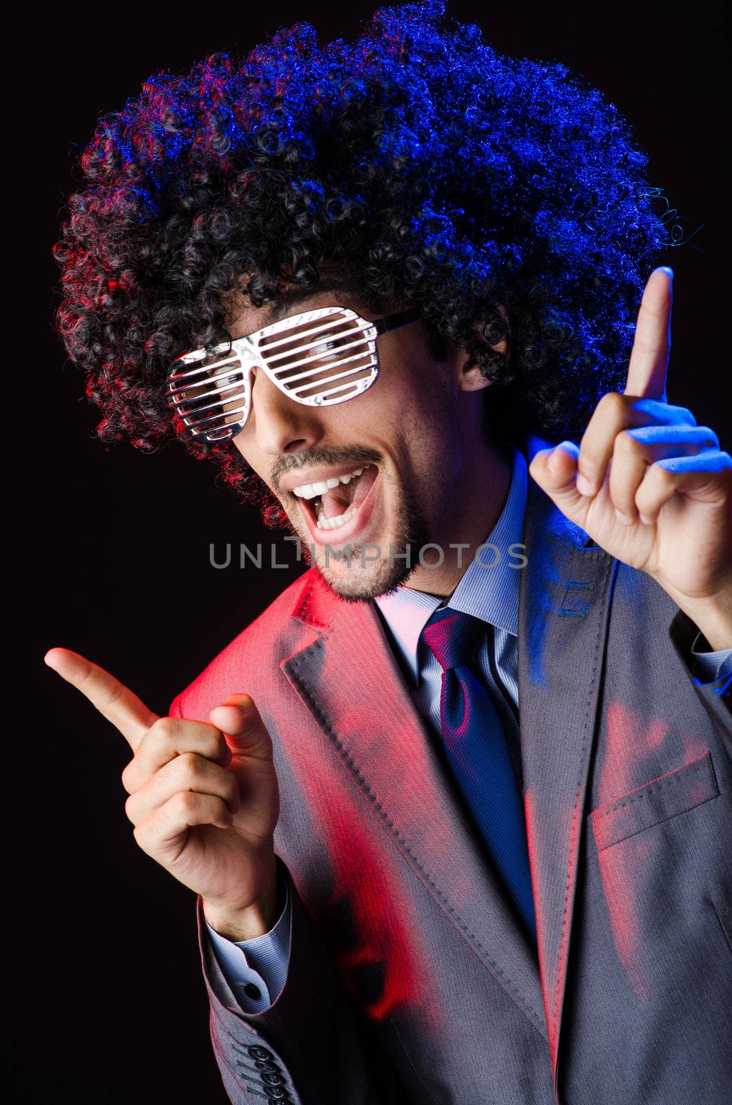 Singer with afro cut in dark studio