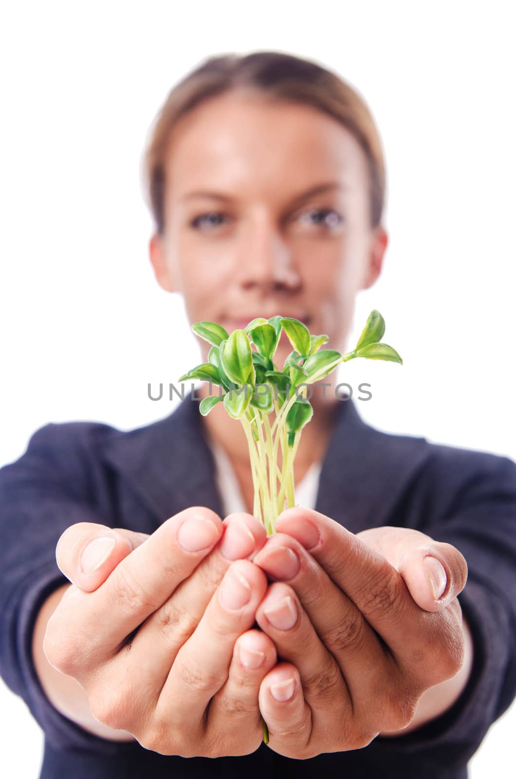 Businesswoman with seedling on white