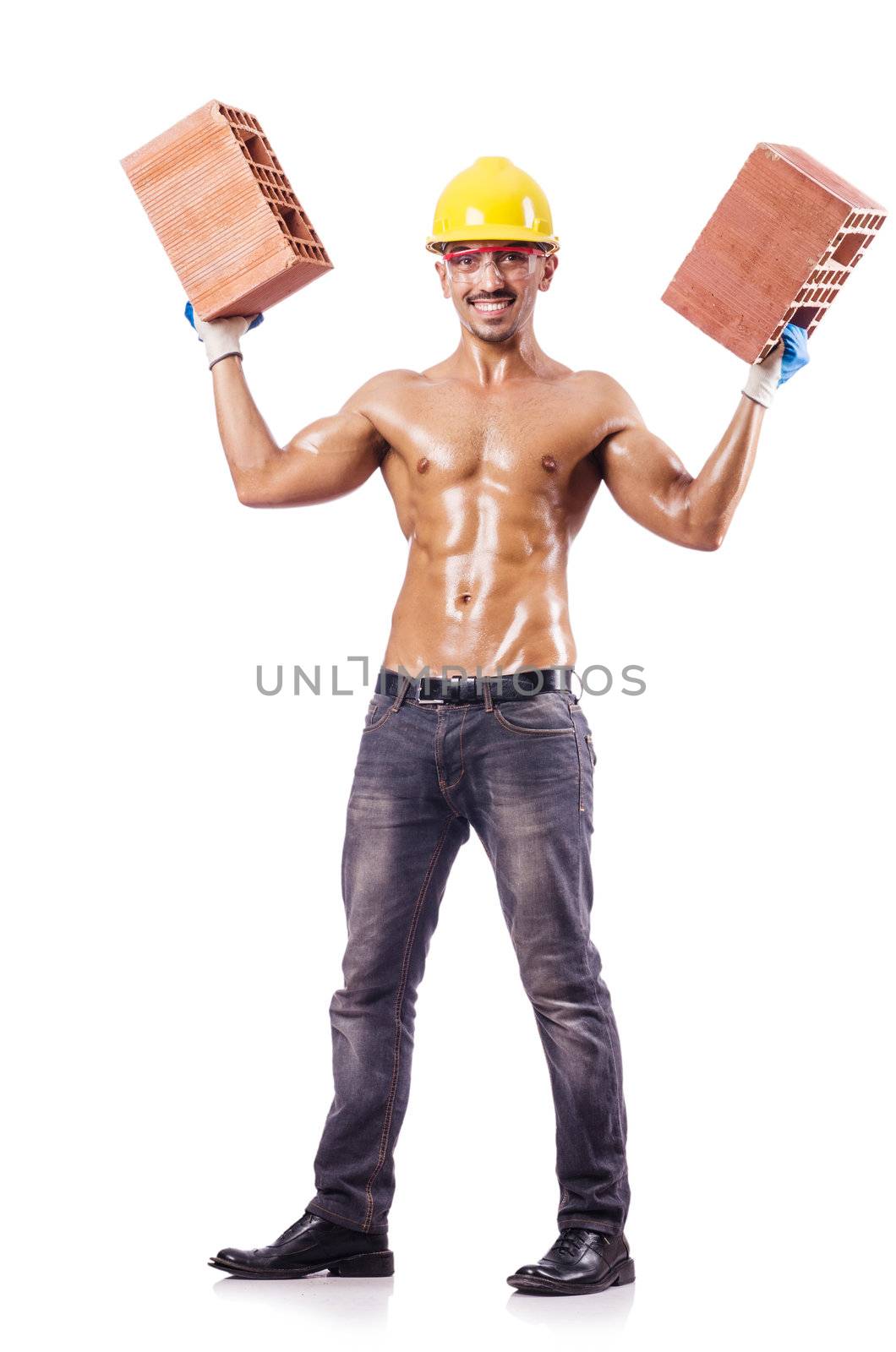 Muscular builder with bricks on white