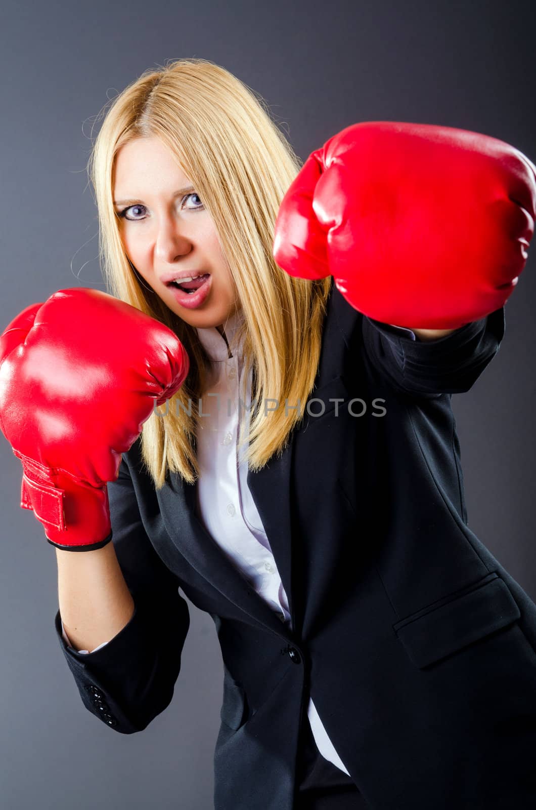 Woman boxer in dark room