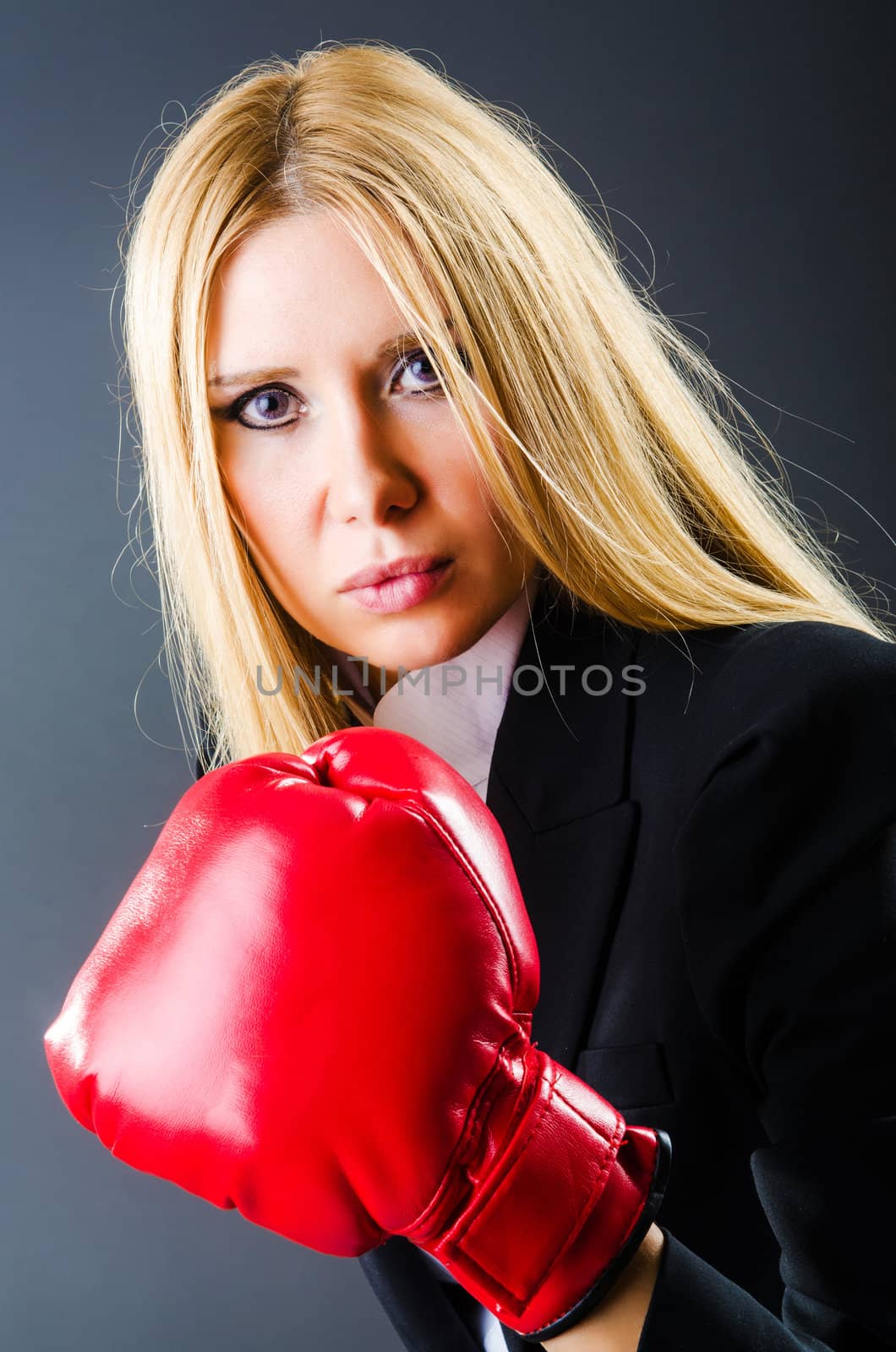 Woman boxer in dark room