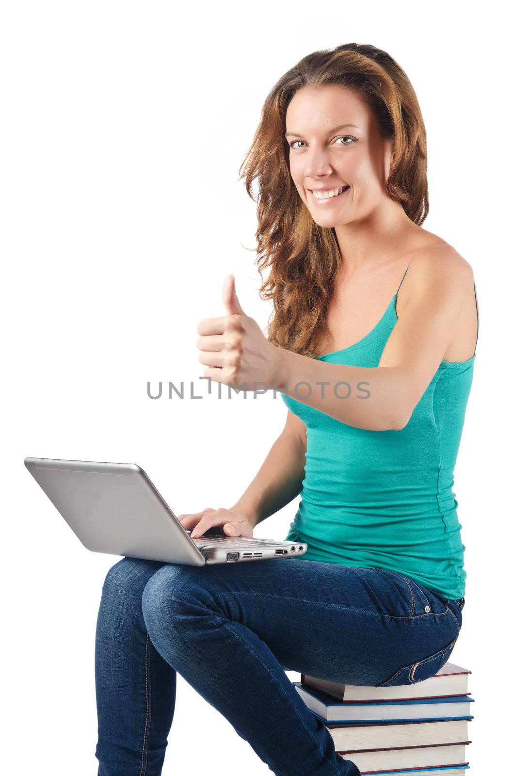 Student with netbook sitting on books