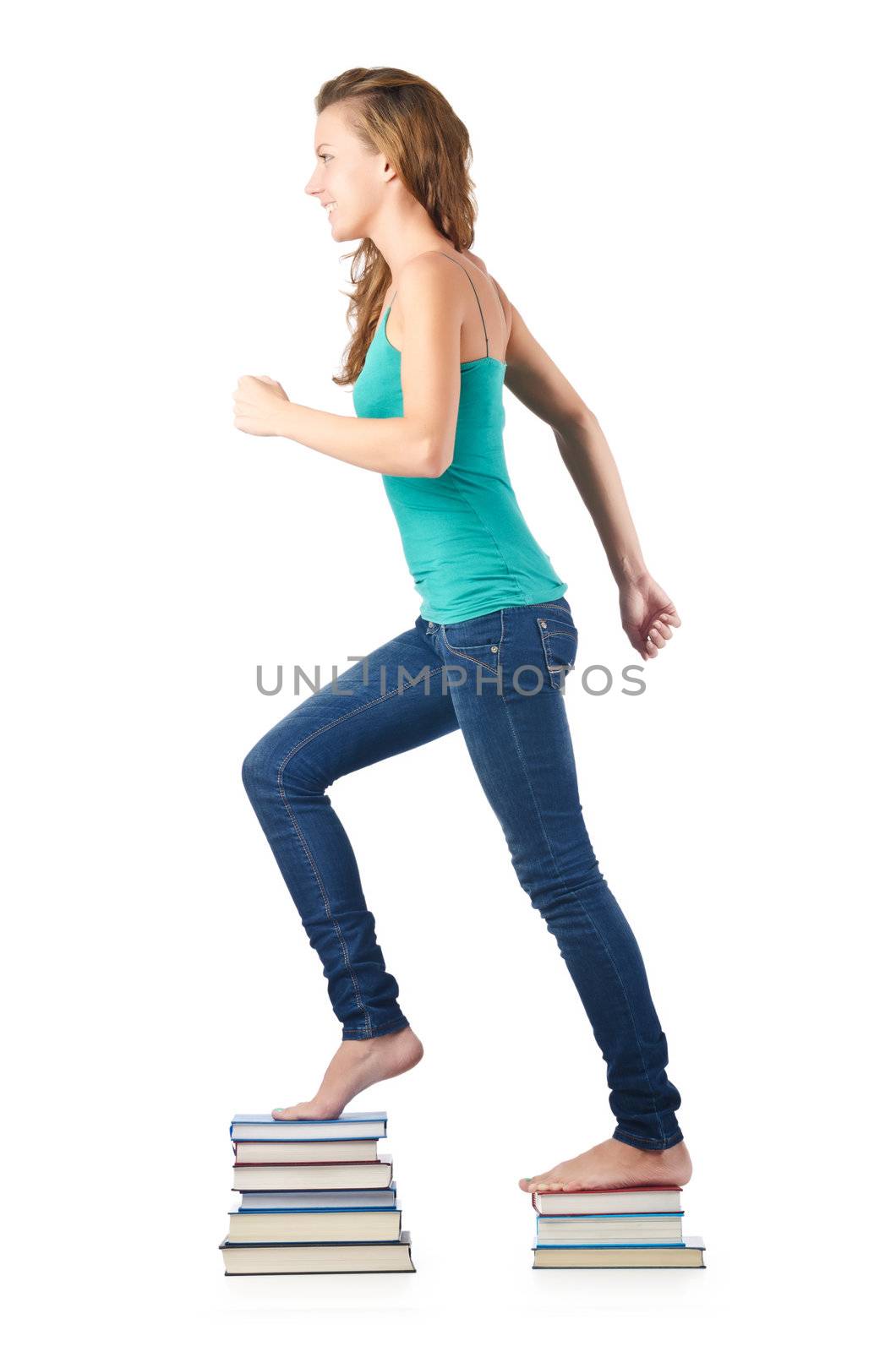 Student sitting on stack of books