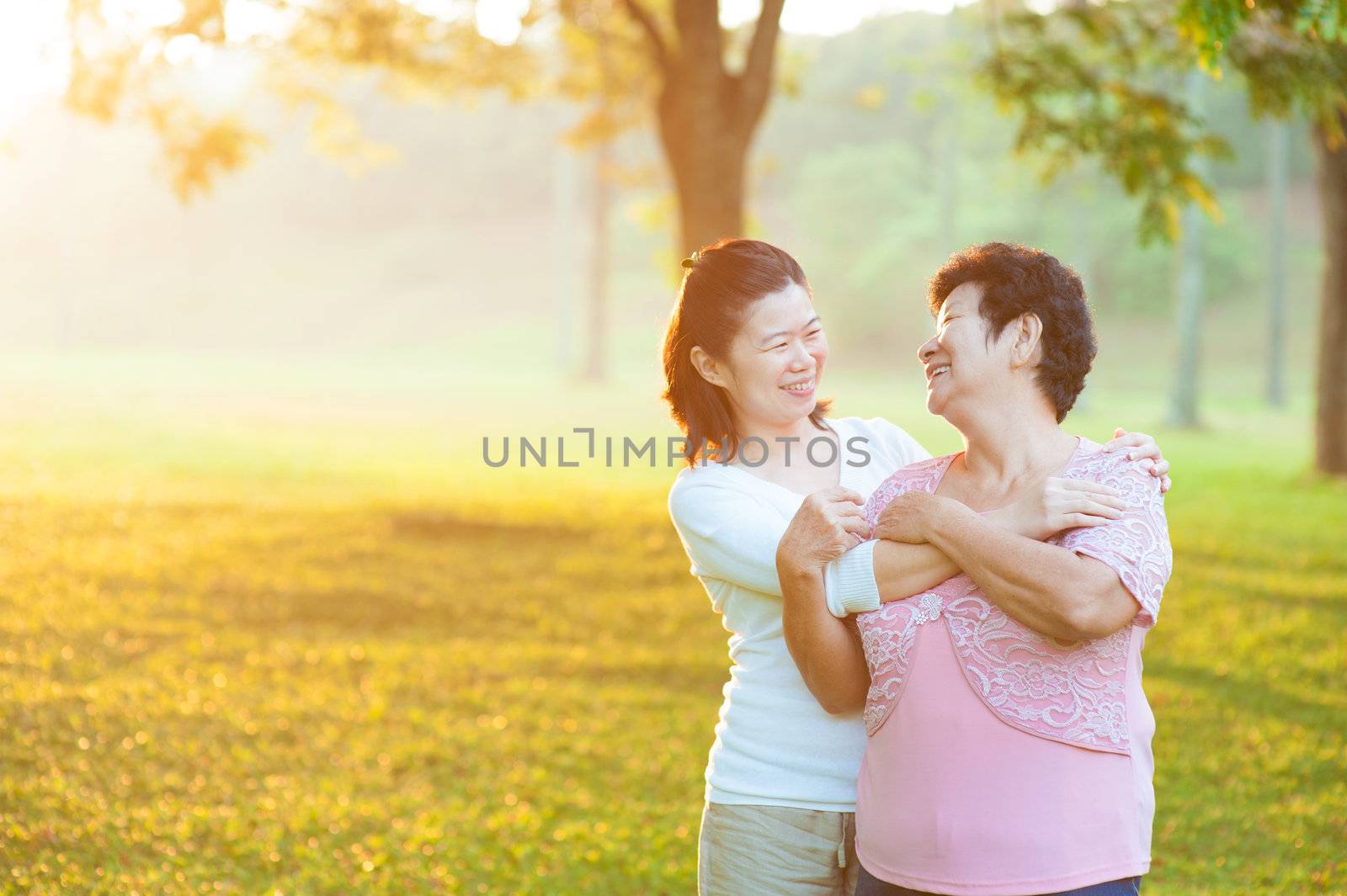 Happy Asian senior mother with her daughter at outdoor park