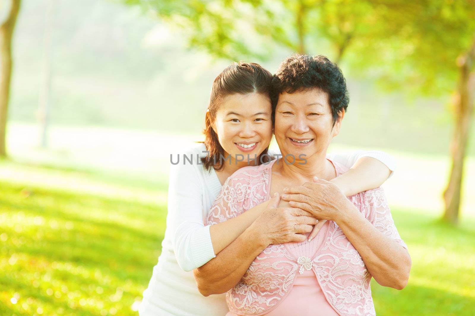 Asian senior mother and adult daughter at outdoor park