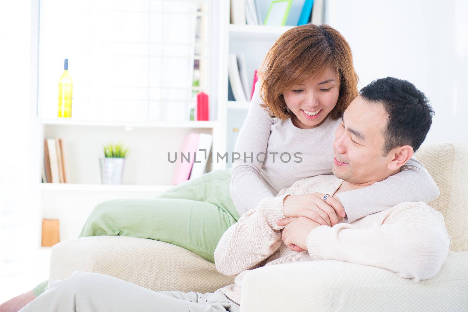 Asian couple having sweet talk at home