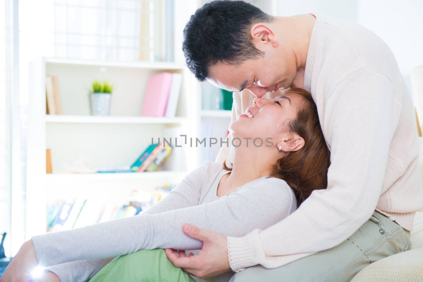 Loving Asian couple having fun time at home