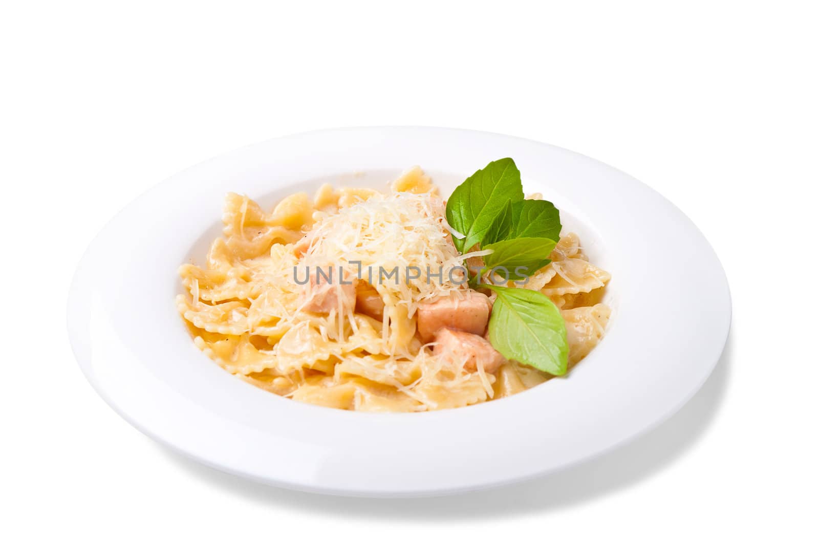 a plate of pasta decorated with basil on a white background