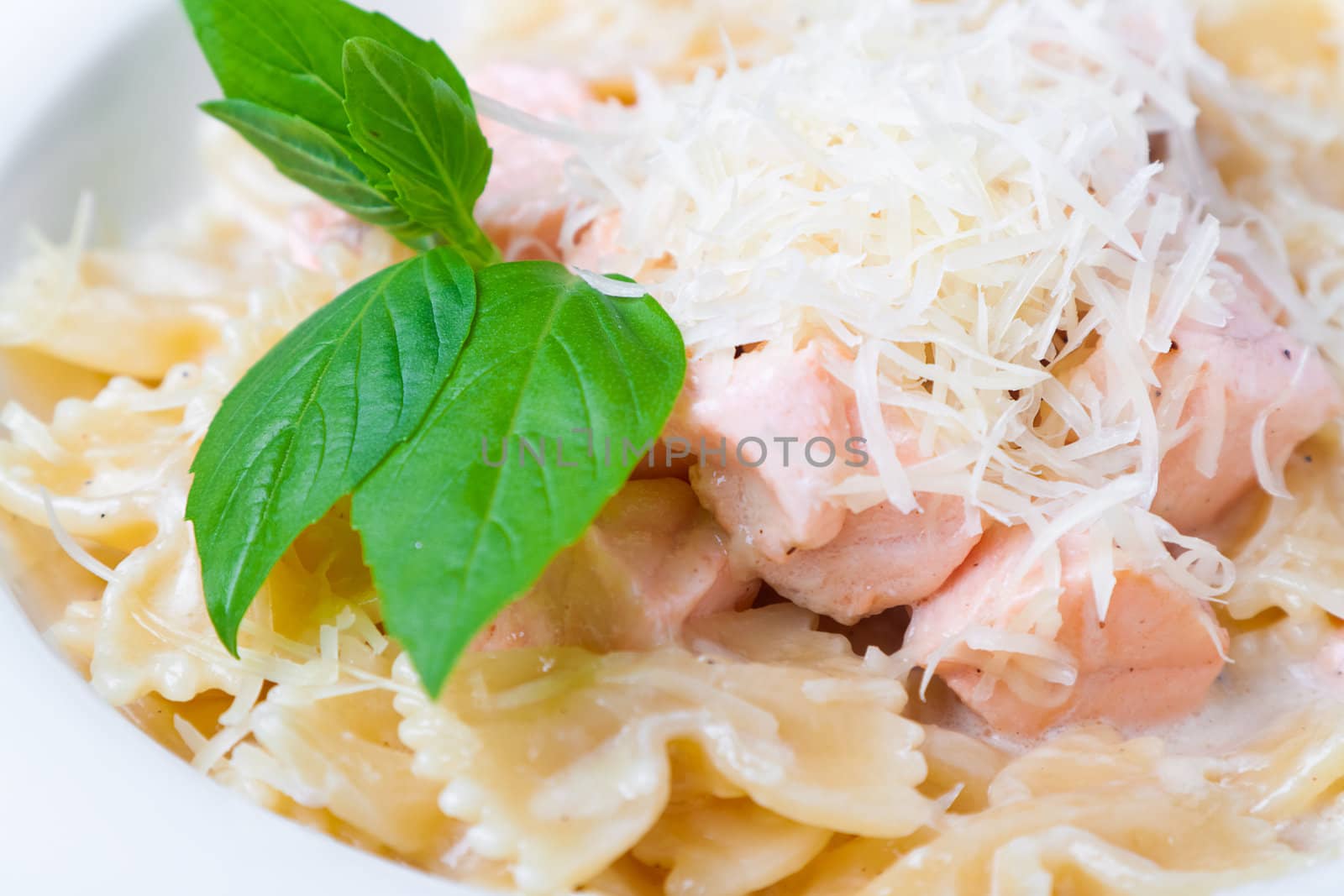 a plate of pasta decorated with basil by Pogost