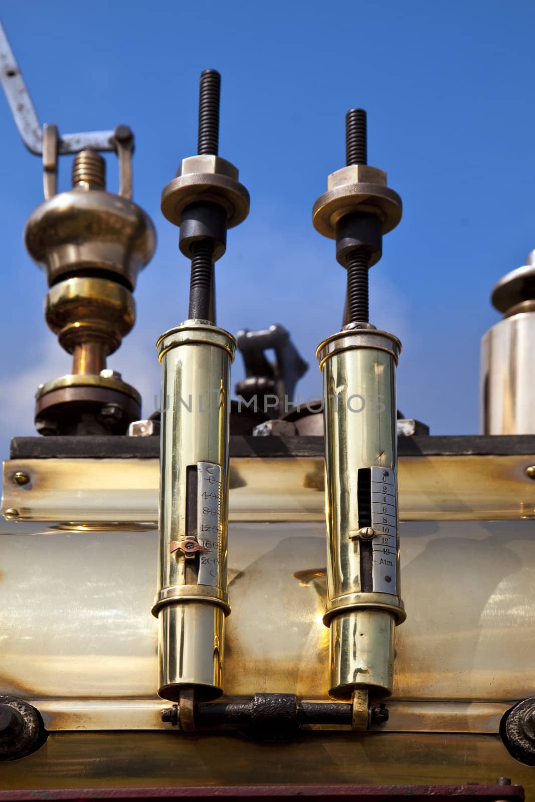 Pair of old brass gauges on a traction engine