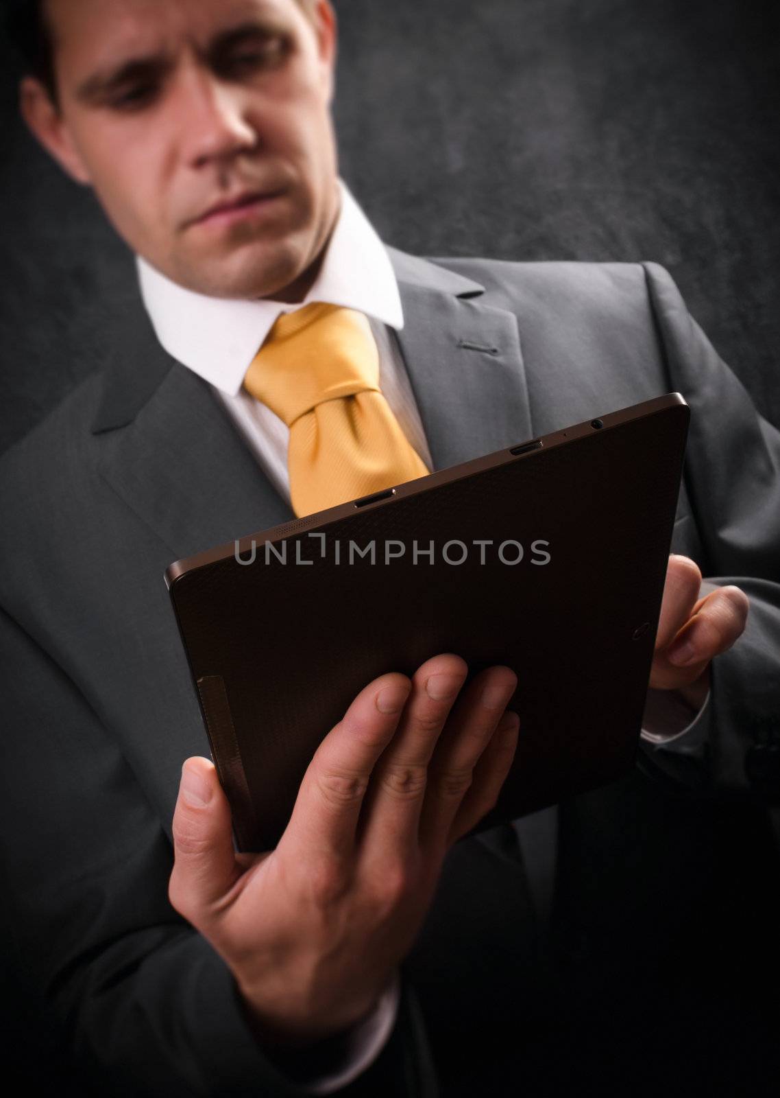 Young businessman checking his business on  a digital tablet. 