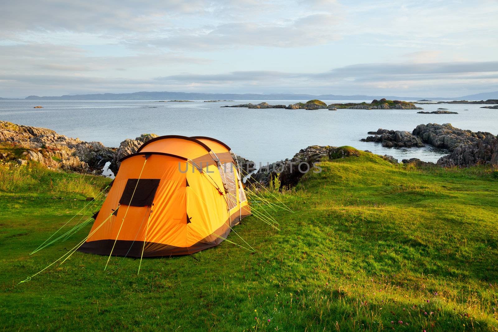 Camping tent on ocean shore by naumoid