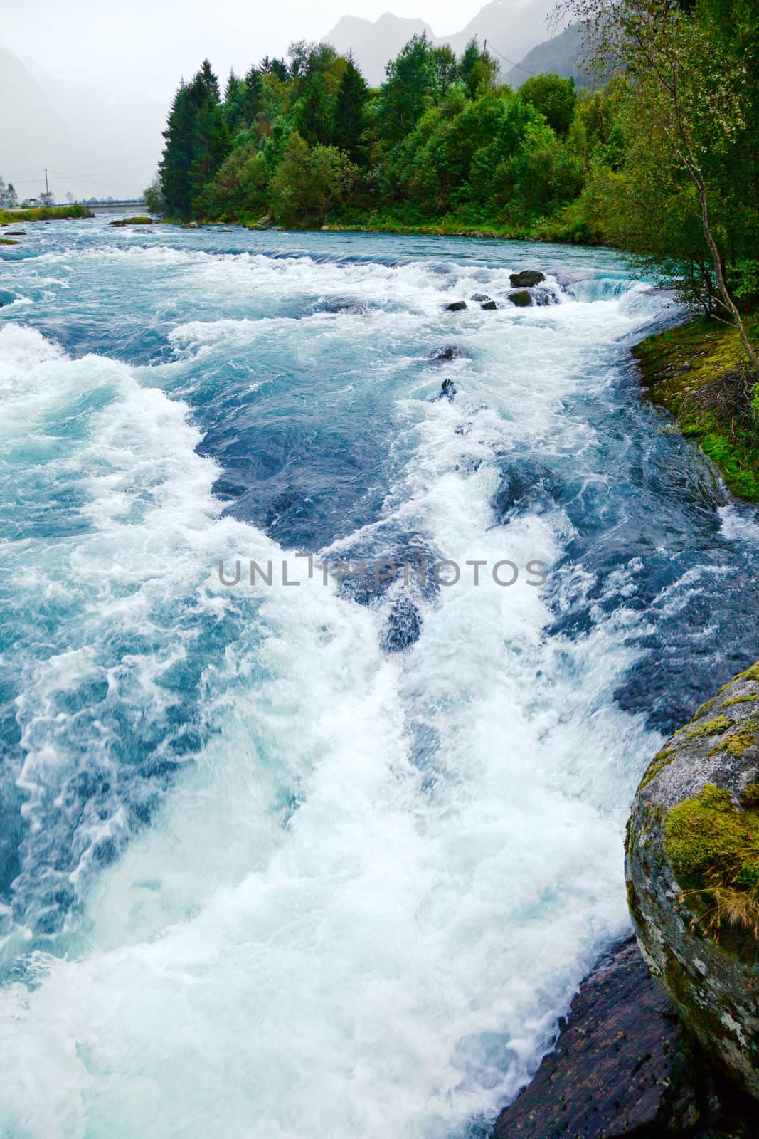 Milky blue glacial water of Briksdal River in Norway
