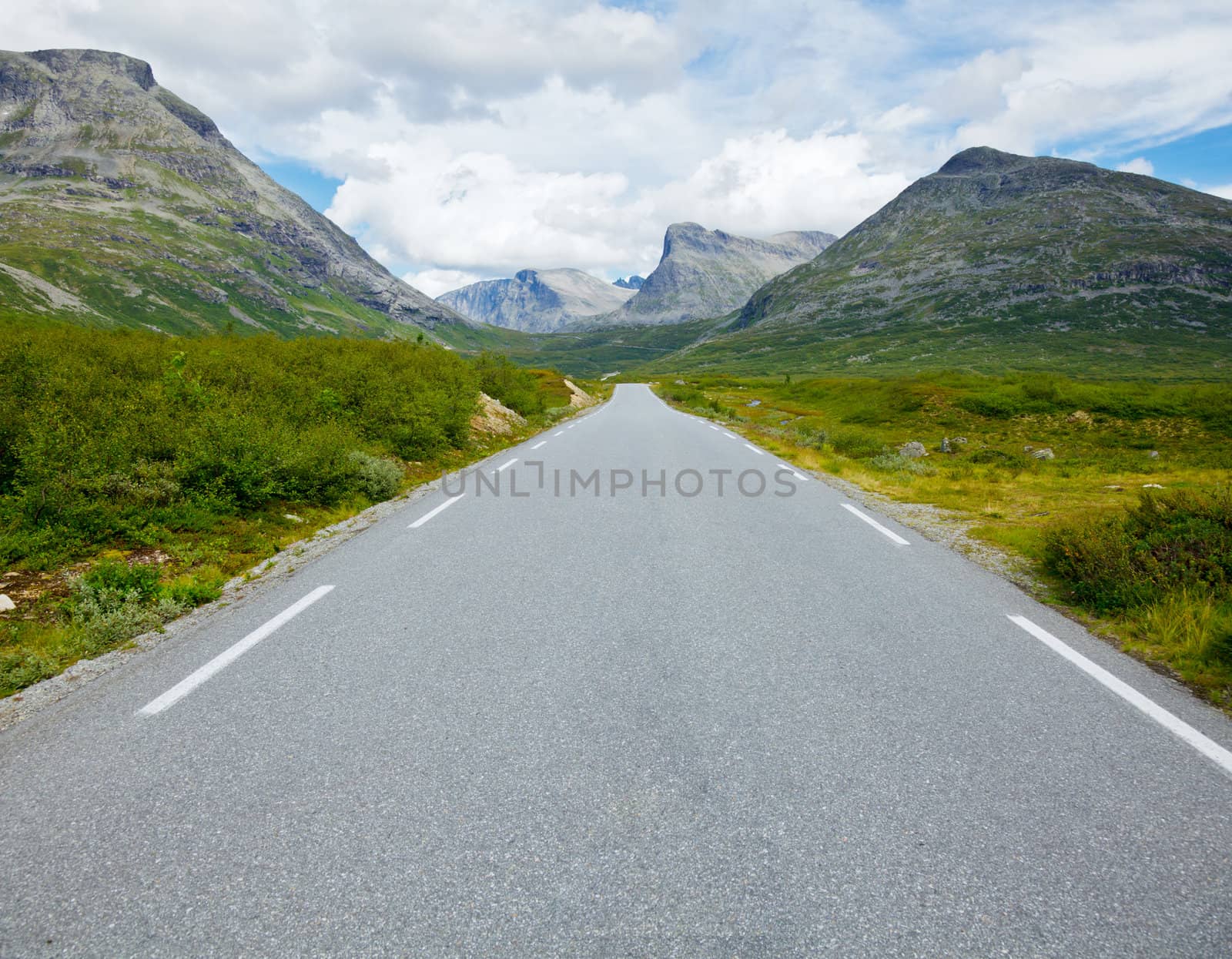 Straight and empty mountain road by naumoid
