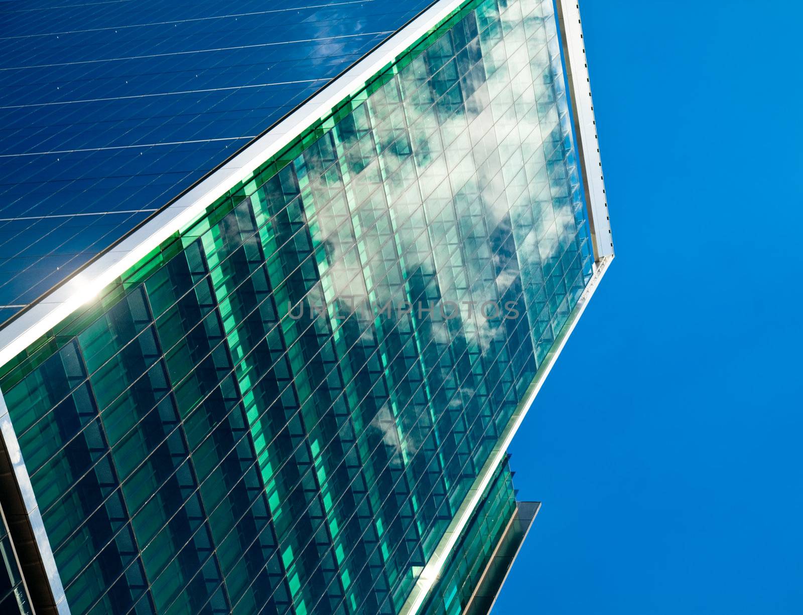 Sky and clouds reflected in a modern office building glass facade