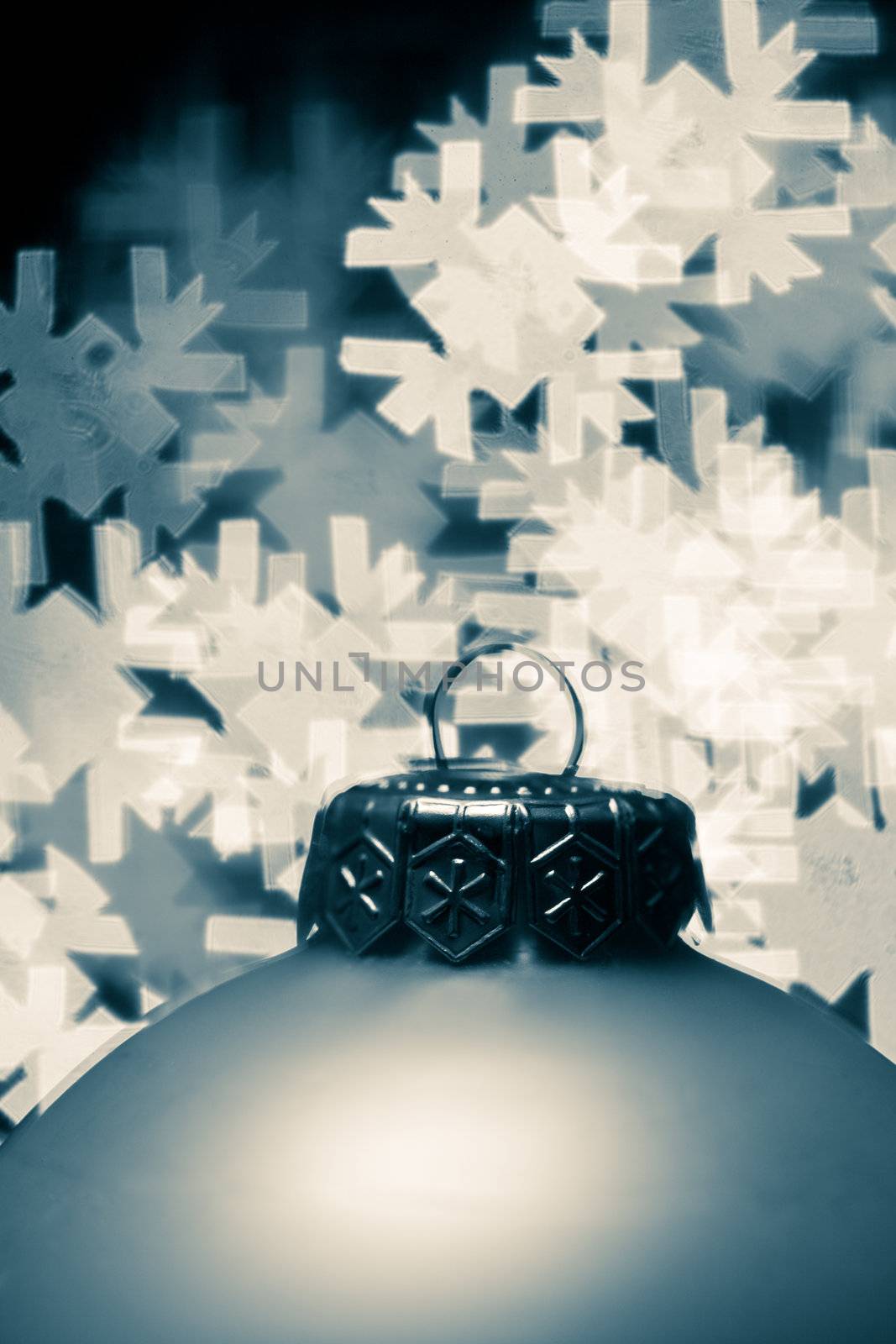 Christmas bauble with blured lights in a shape of snowflake in background, very shallow DOF