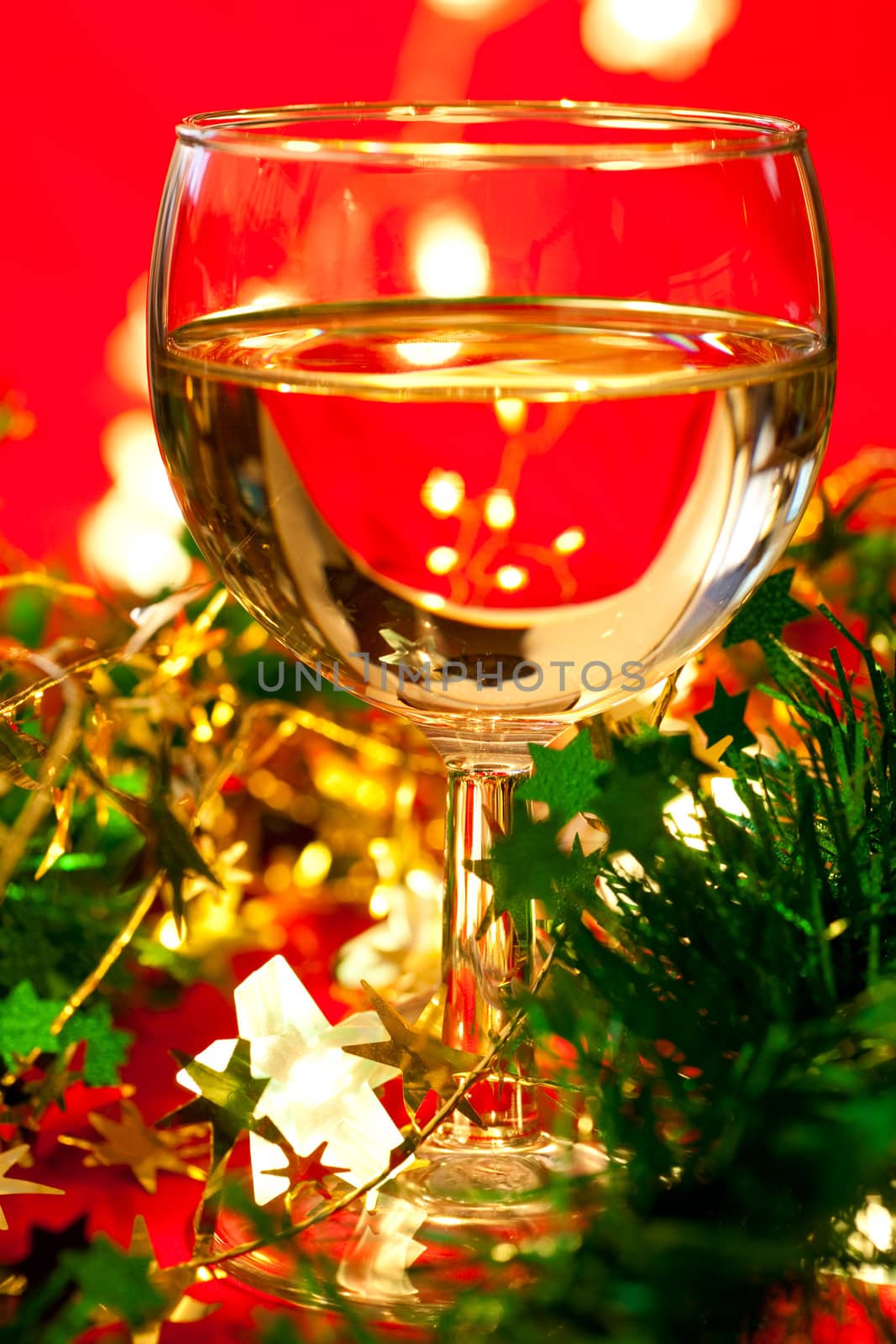 Glass of white wine with Christmas decoration, very shallow DOF