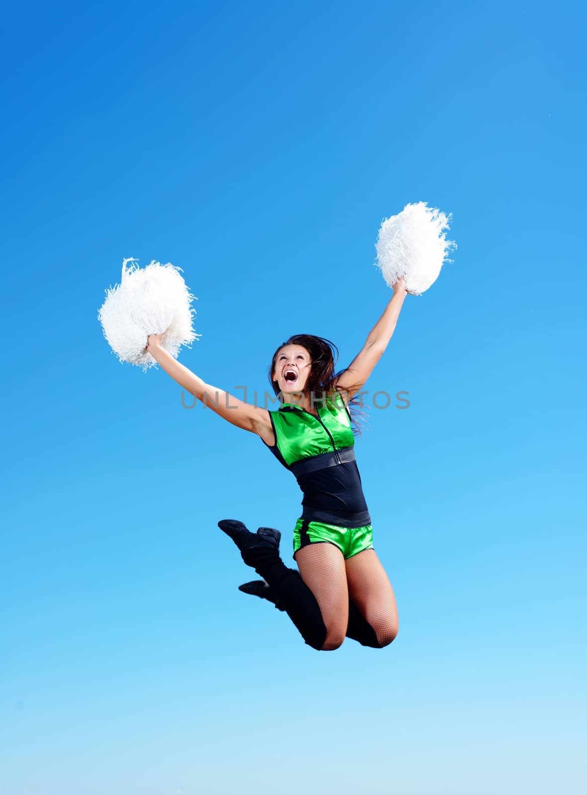 cheerleader girl jumping on a background of blue sky