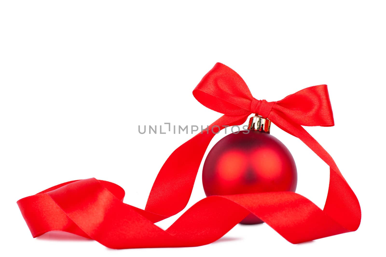 Red christmas decoration with red bow over white background