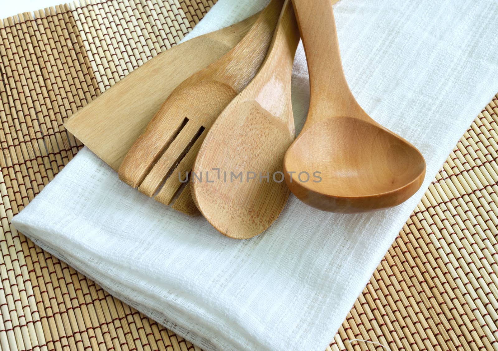 Wooden cooking utensils on wood background