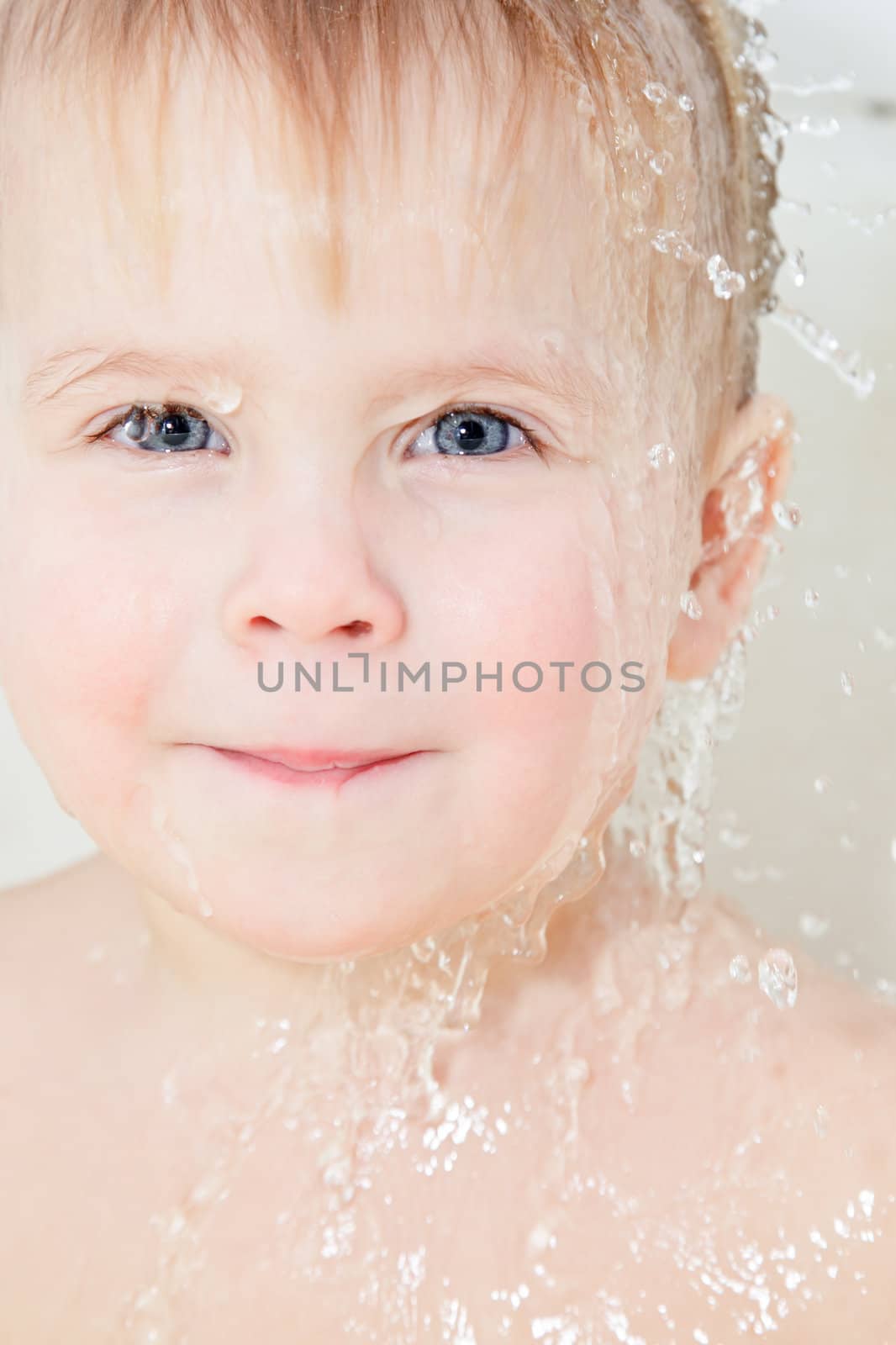 Portrait of cute little girl with water dripping through her head