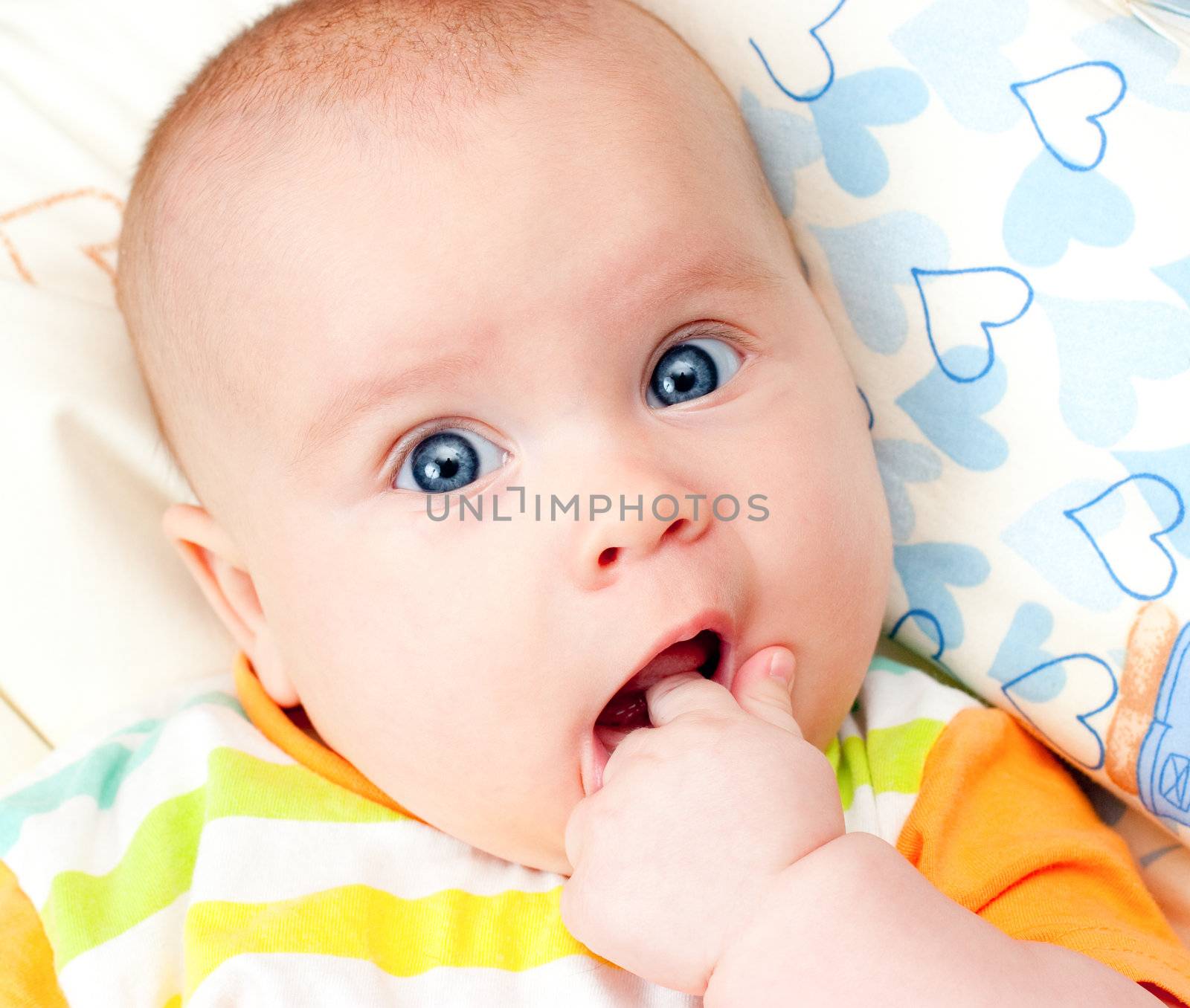 Infant with hand in mouth by naumoid