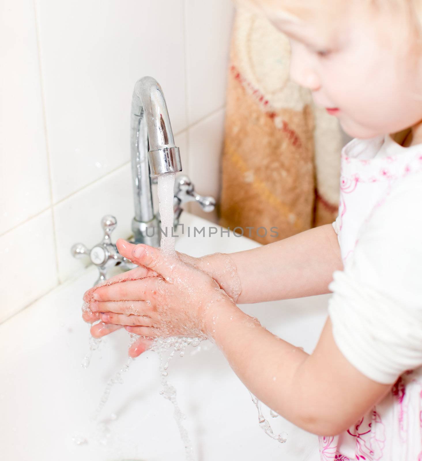 Little girl washing hands by naumoid