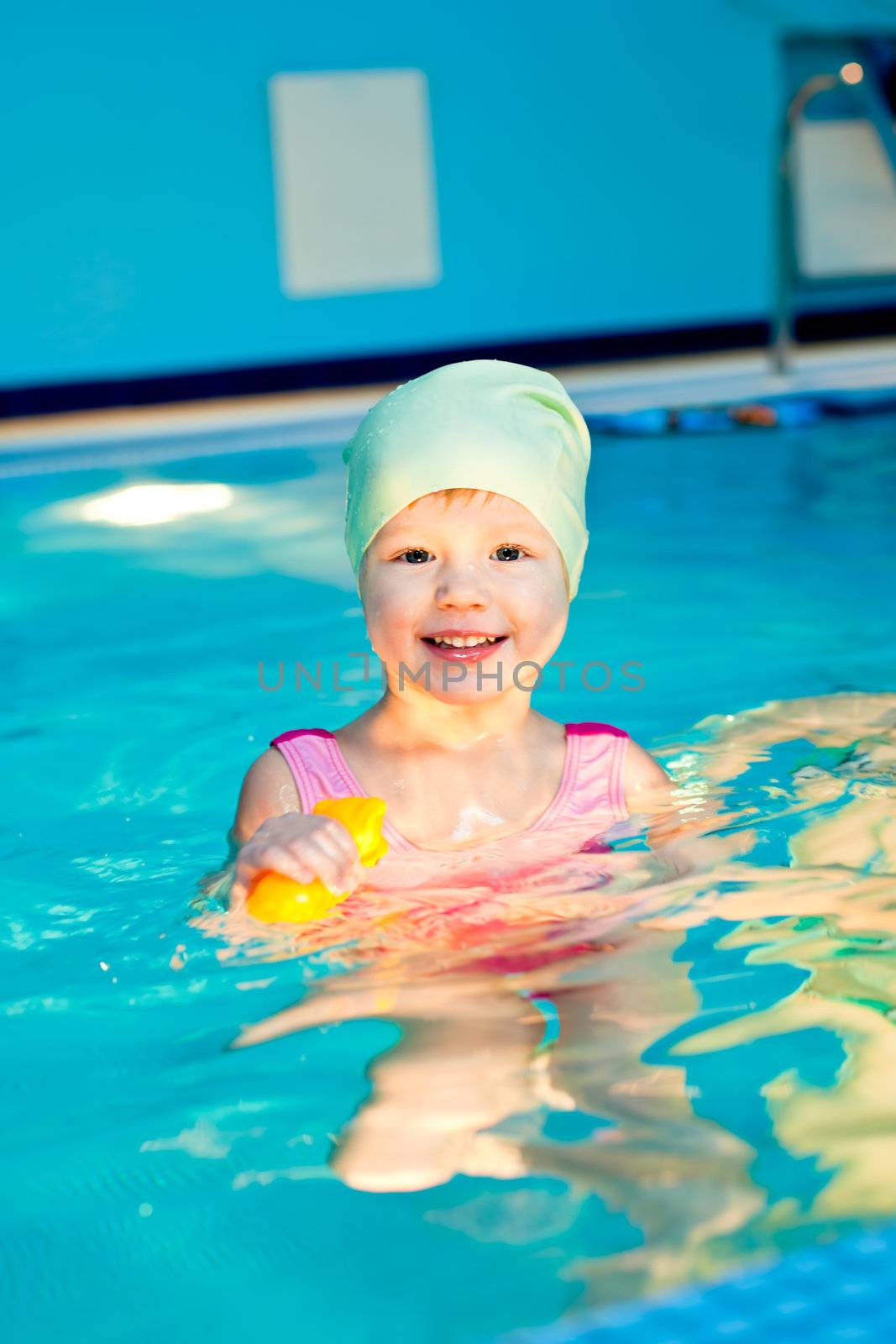Cute little girl swimming in a pool